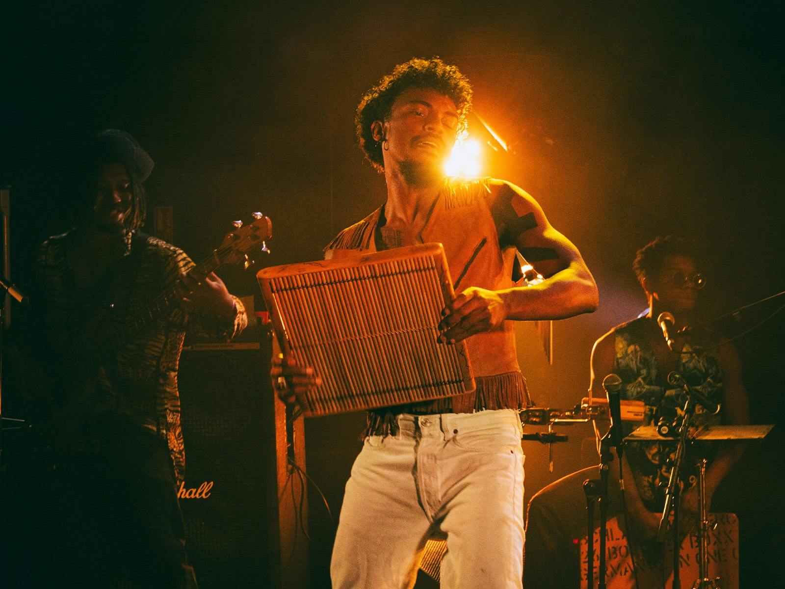 Artist Claudio Rabe performing on stage with instrument