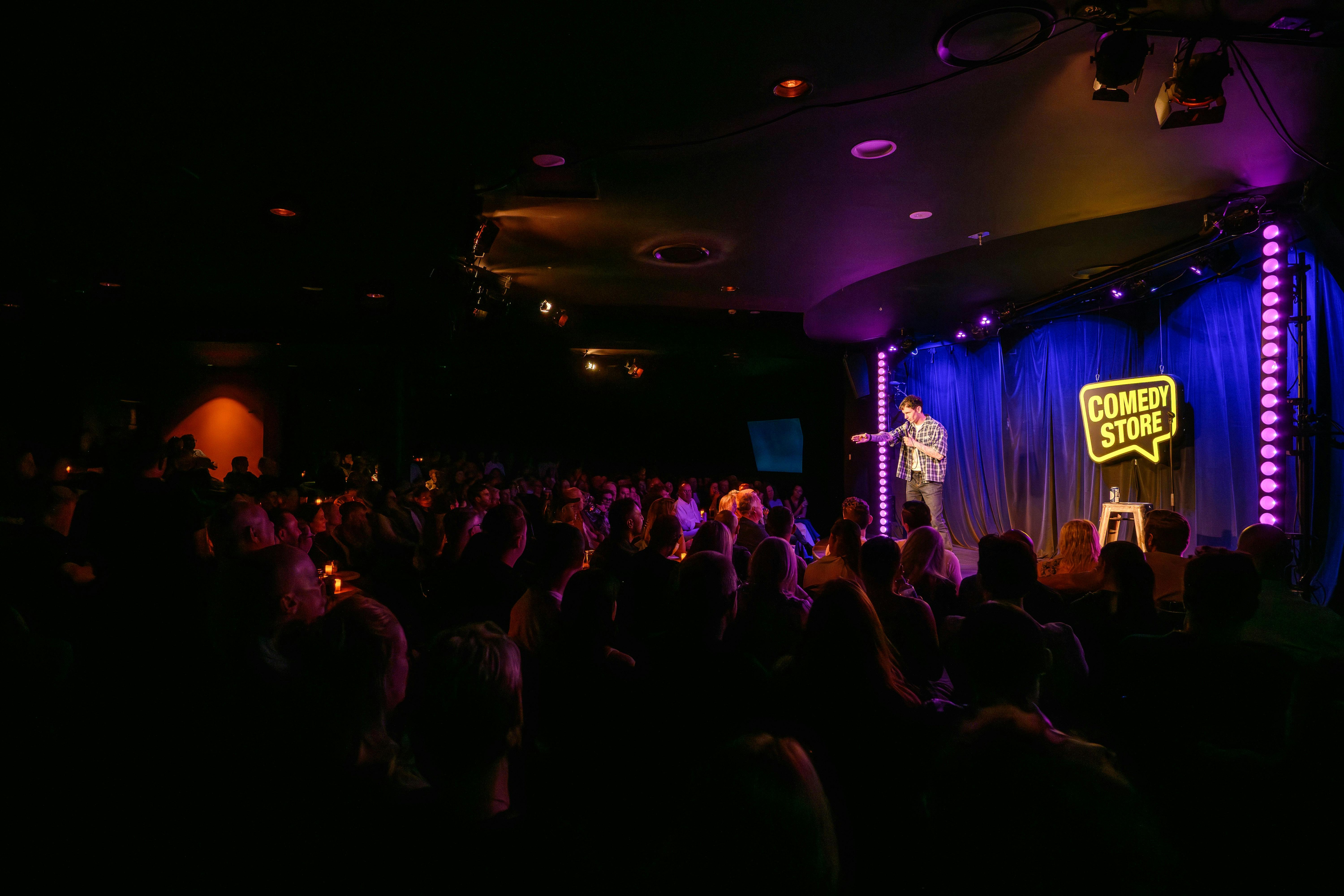 Live comedy performance taking place at The Comedy Store theatre.