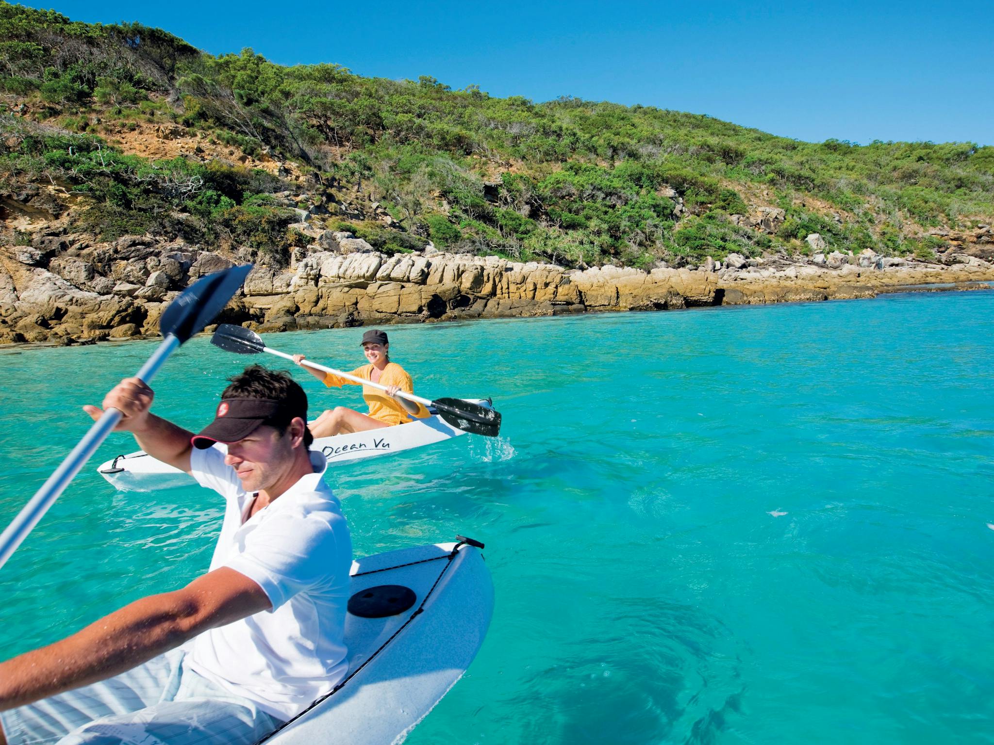 Kayaers on blue waters with islands in background, Keppel Islands