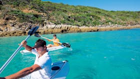 Kayaers on blue waters with islands in background, Keppel Islands