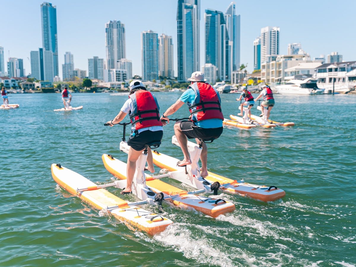 Couple pedalling double waterbike on Nerang River