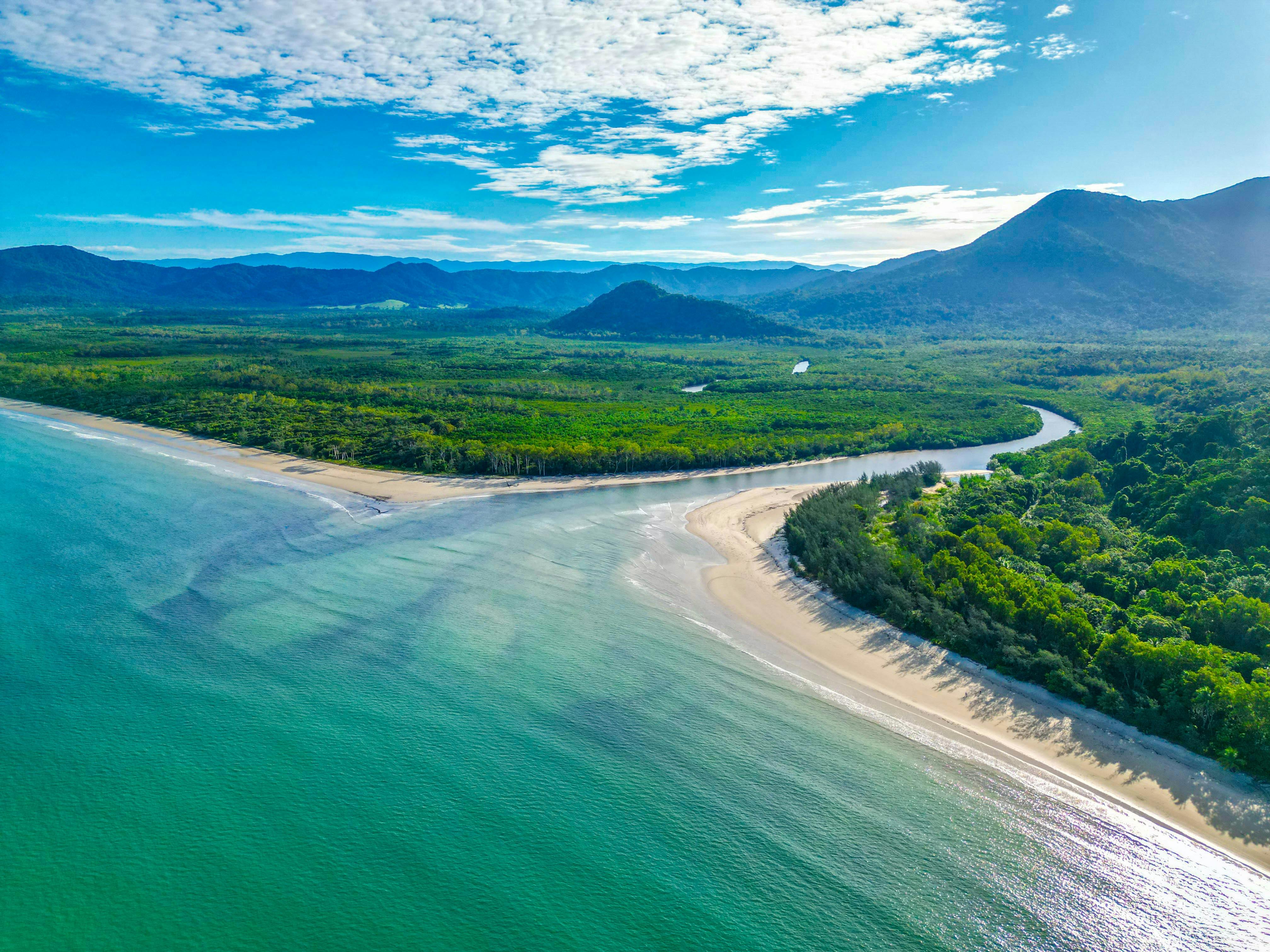 Scenic view of the Daintree River surrounded by lush rainforest in Far North Queensland.