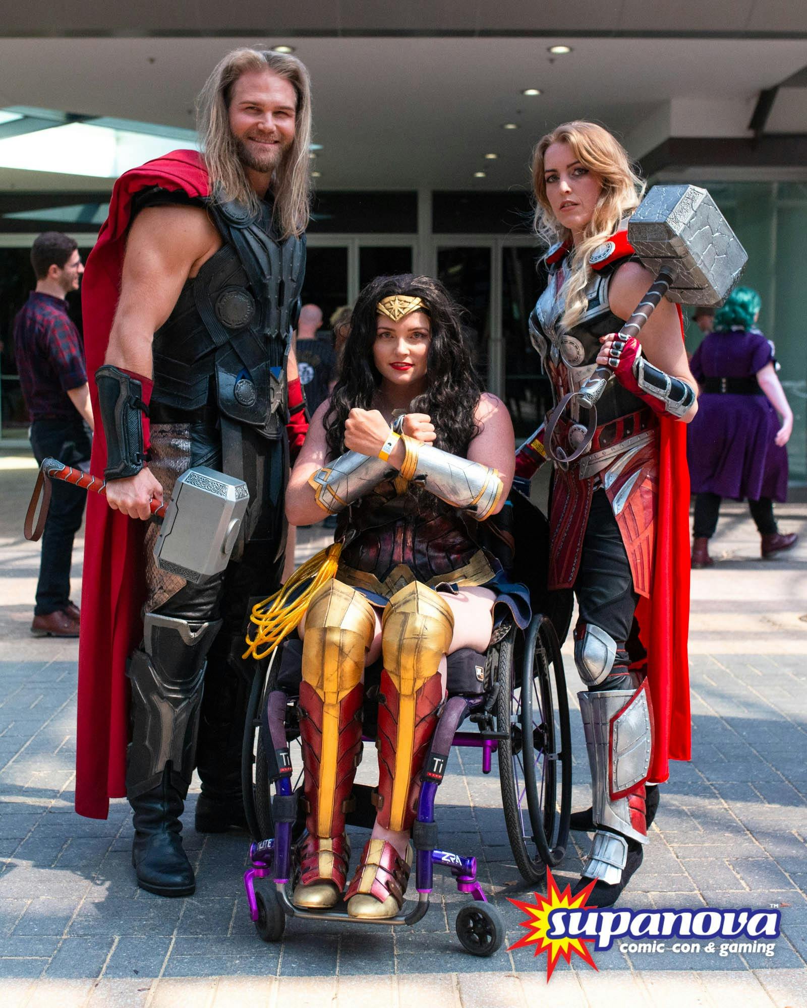 Three cosplayers posing for a photo at Supanova Comic Con and Gaming, dressed as superheroes