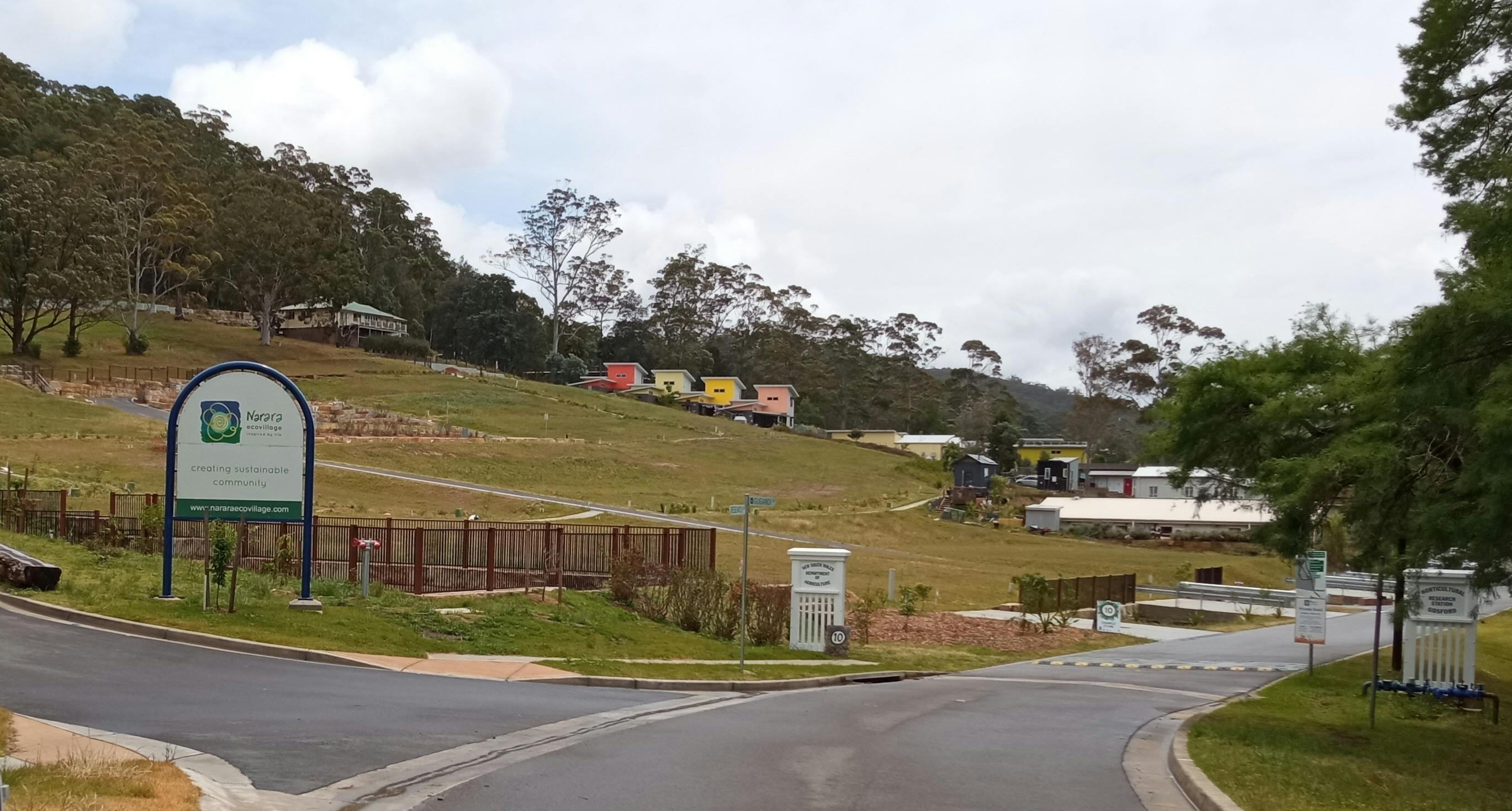 A welcome sign at the side of the entrance road