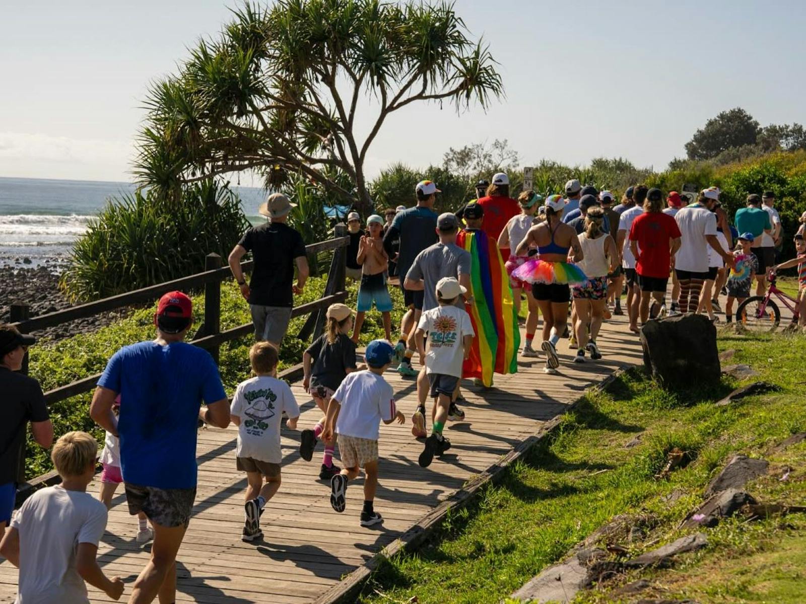 Crowd of people running along the Lennox coastal pathway