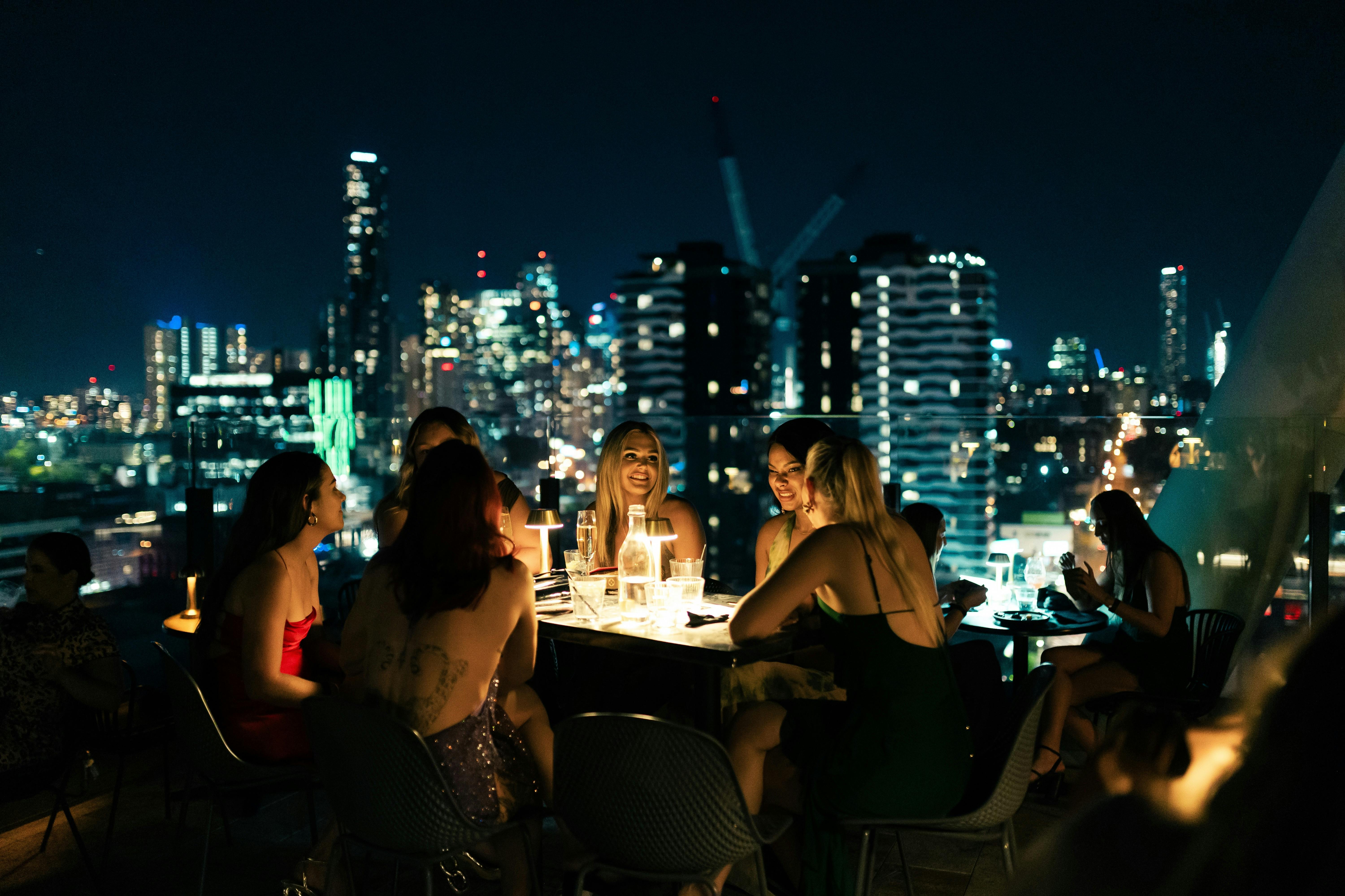 A groups of friends enjoying drinks and Soko's a la carte menu on the outdoor terrace