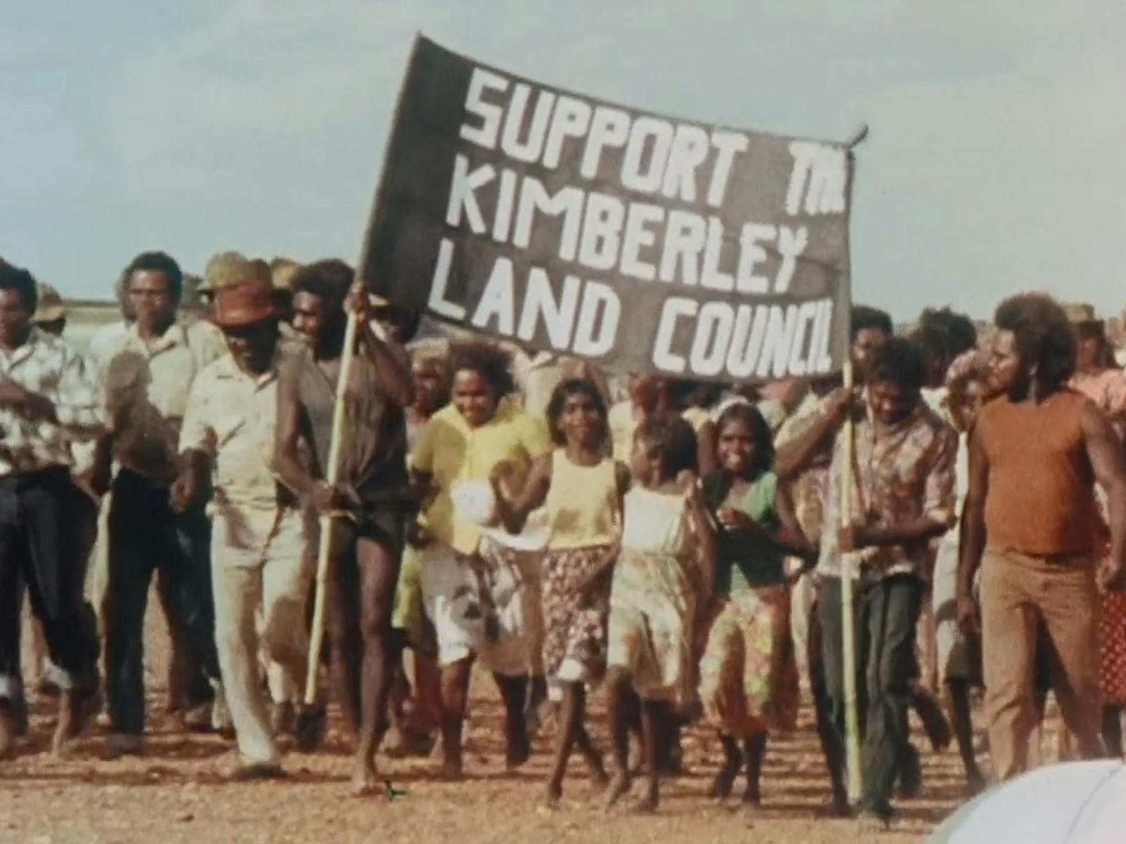 Protest with group of people holding sign saying support to Kimberley land council