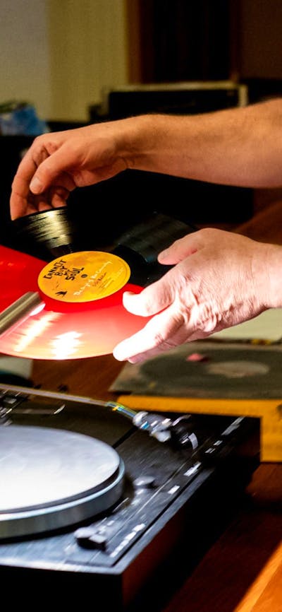 Close up of man preparing to play vinyl