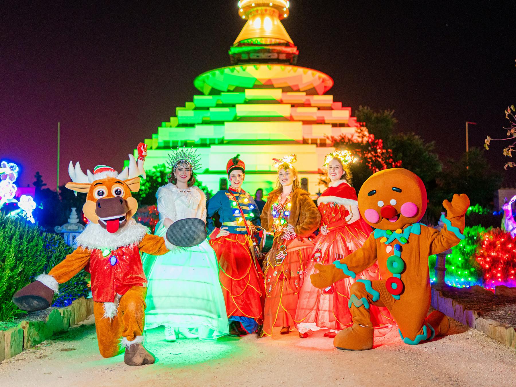 group of mascots in front of the great stupa in christmas outfits