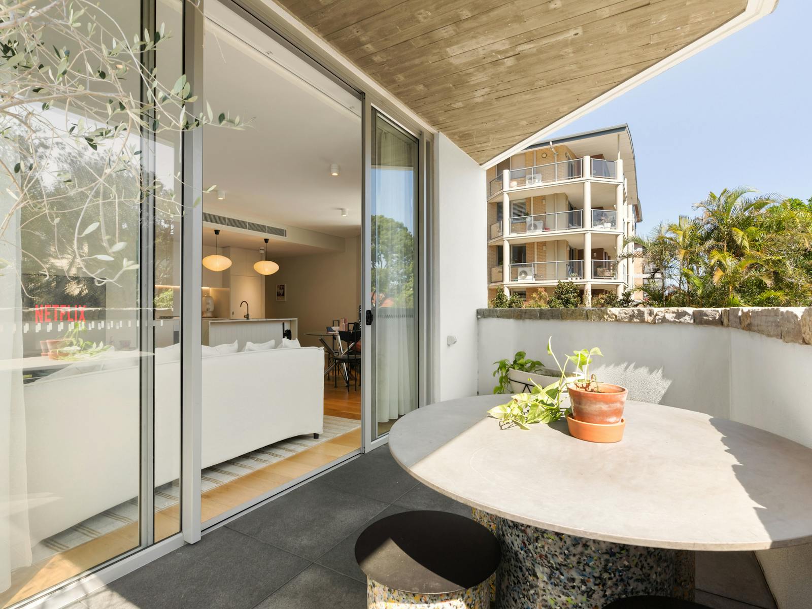 Spacious balcony with a small table, perfect for outdoor relaxation.
