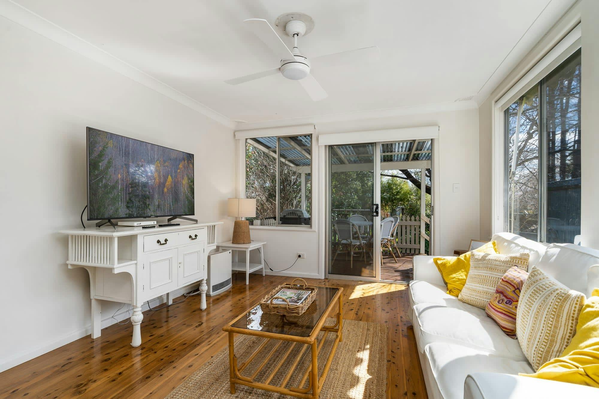 Lounge with a tv and door to outdoor