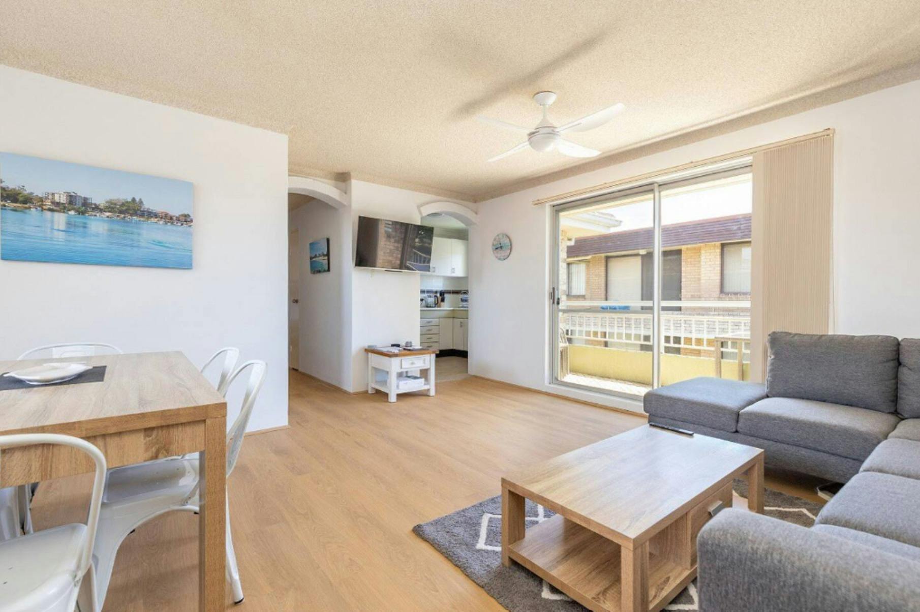 Lounge and dining with TV, ceiling fan, corner lounge and dining setting