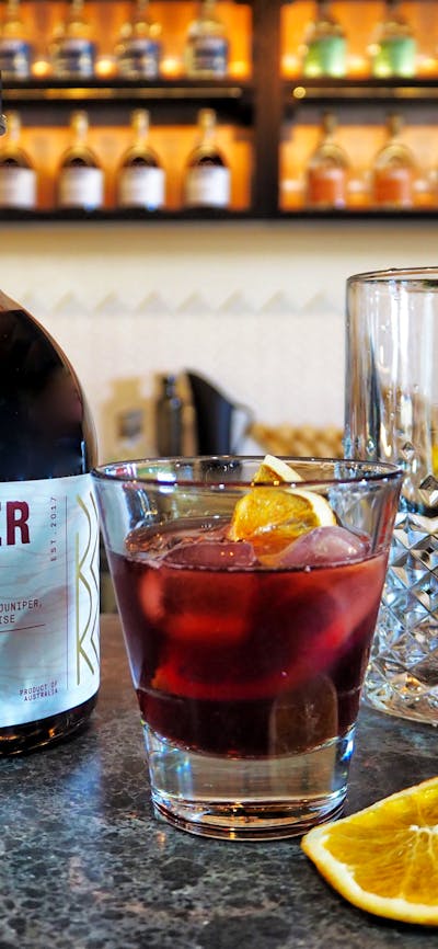 Syrah Gin bottle and negroni cocktail