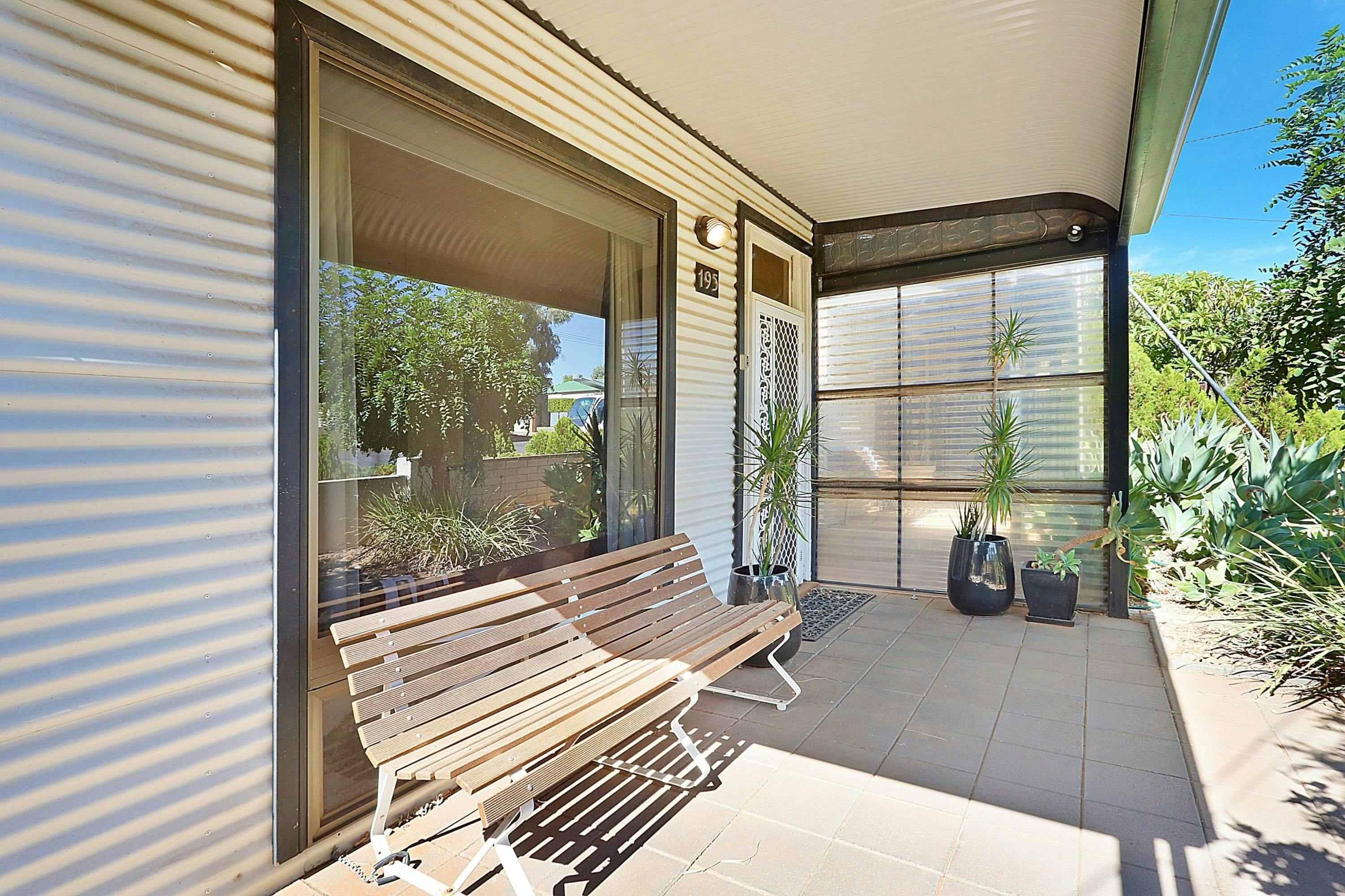 The front veranda  is the perfect place to sit and take in the garden and neighbourhood
