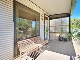 The front veranda  is the perfect place to sit and take in the garden and neighbourhood