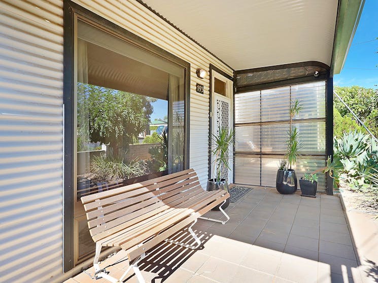 The front veranda  is the perfect place to sit and take in the garden and neighbourhood