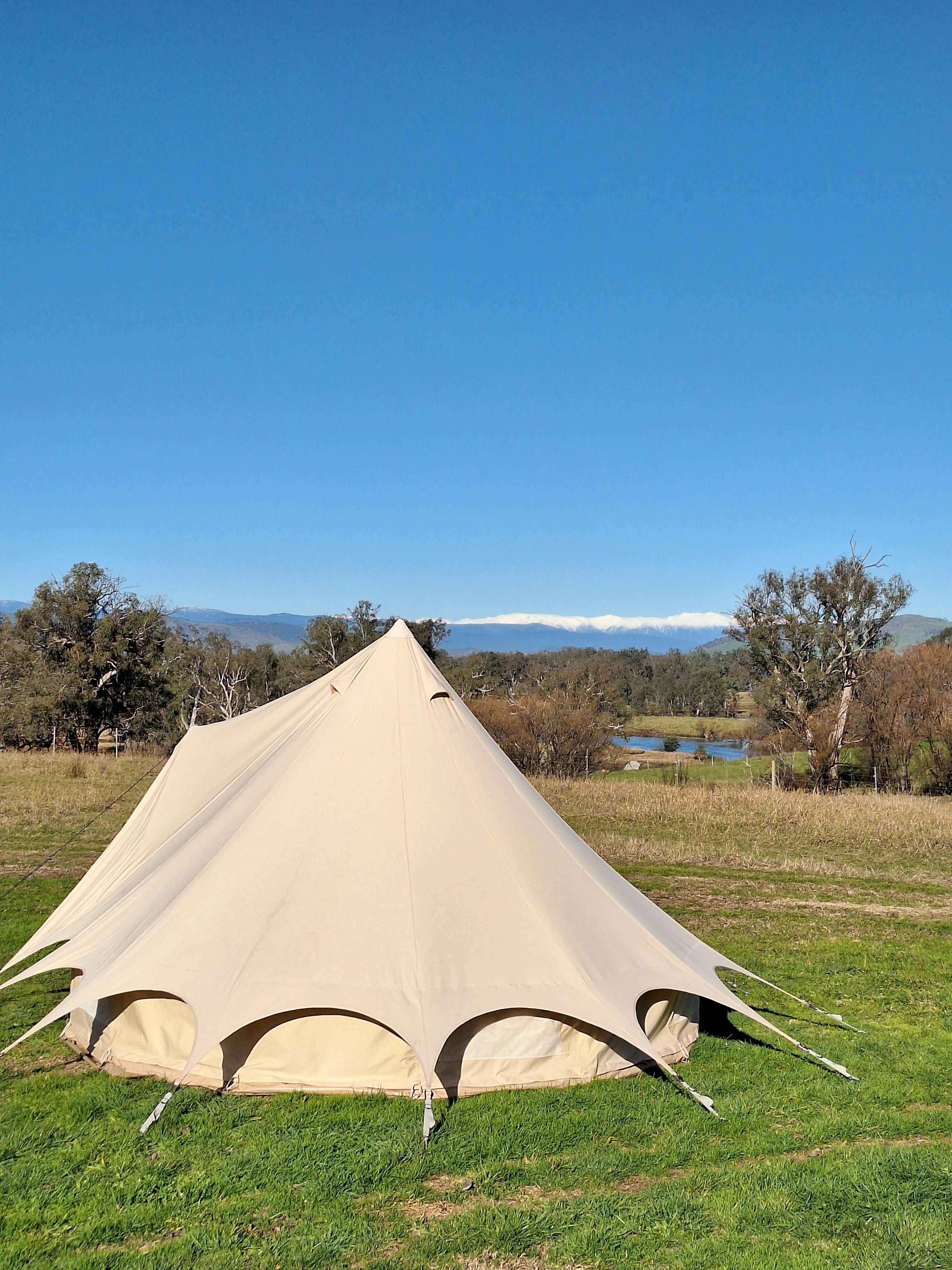 outside the glamping tent overlooking the trees and water
