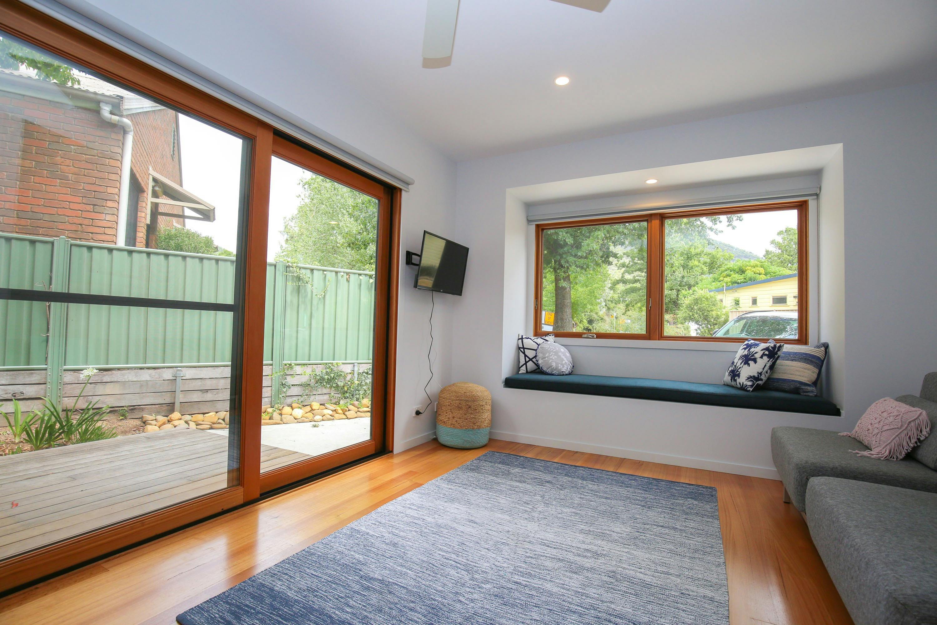 TV room with day bed at The Stelvio Villas Two Bright Accommodation Alpine Valley Getaways