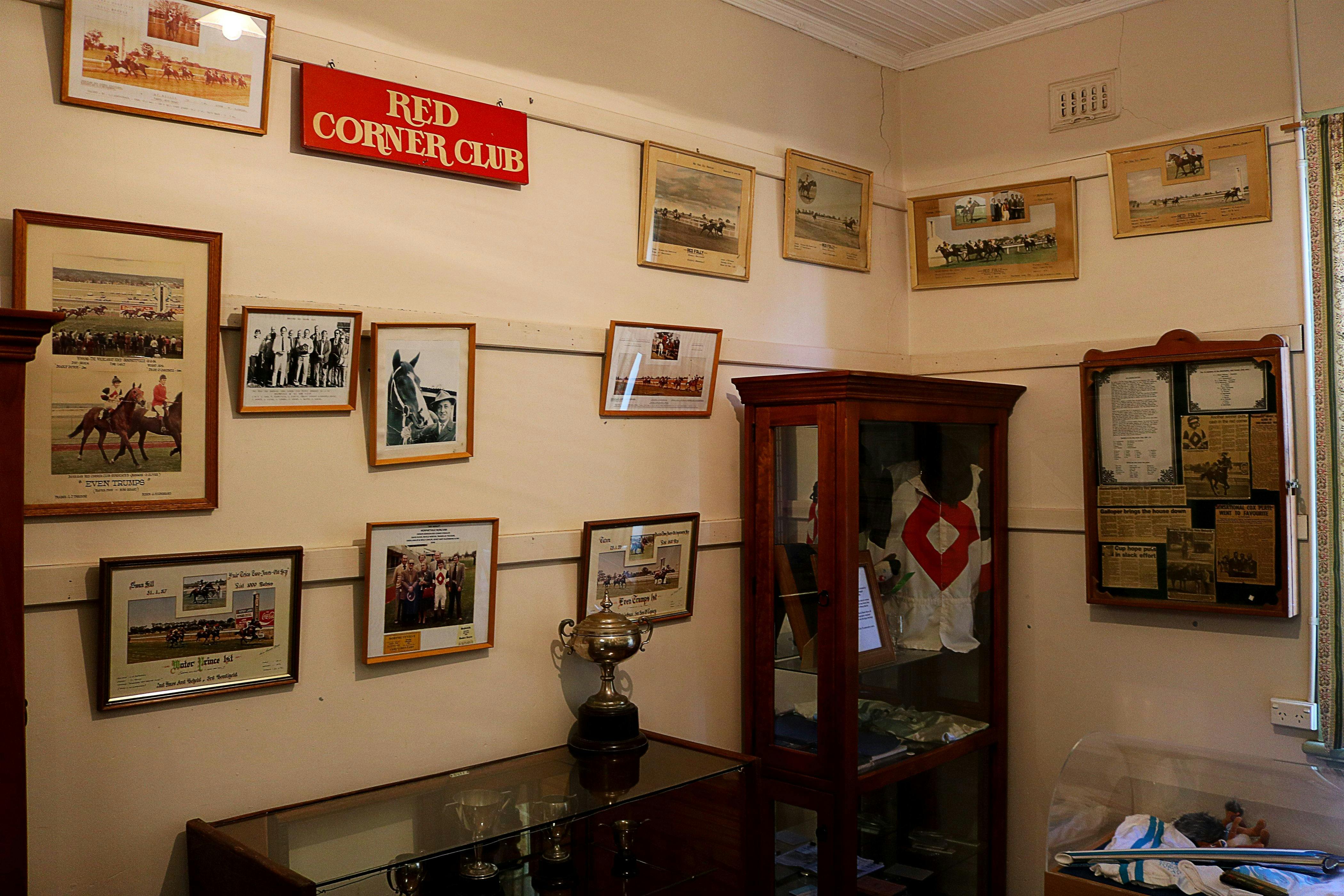 Museum interior with frames of horse racing memorabilia on the wall