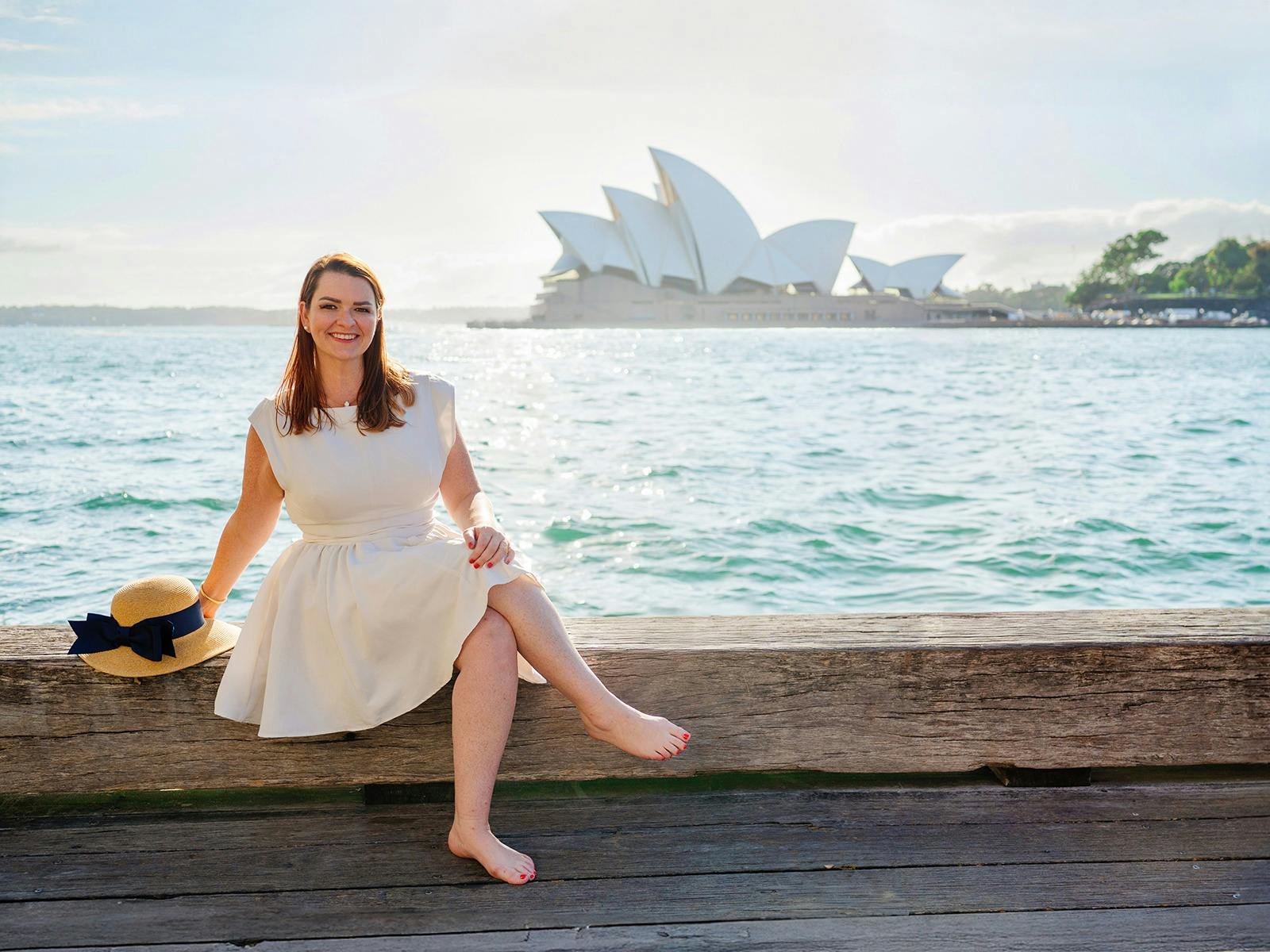 Woman enjoying a Sydney Opera & Harbour Portraits session with Opera House and Harbour Bridge.