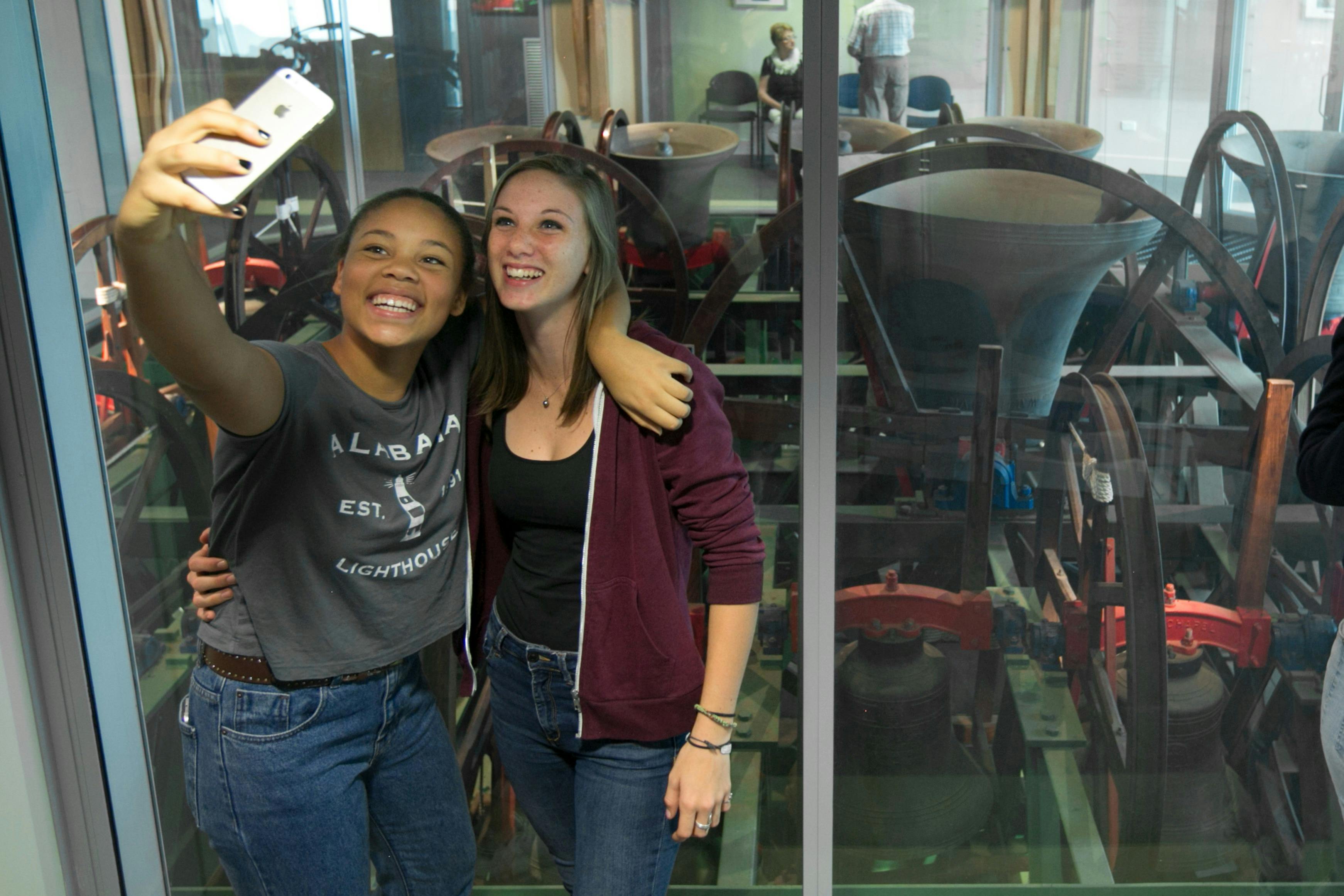 A couple take a selfie in front of the St Martin-in-the-Fields bells