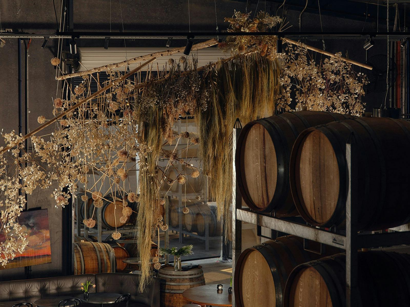 The winery and dining area with a floral installation hanging from the ceiling