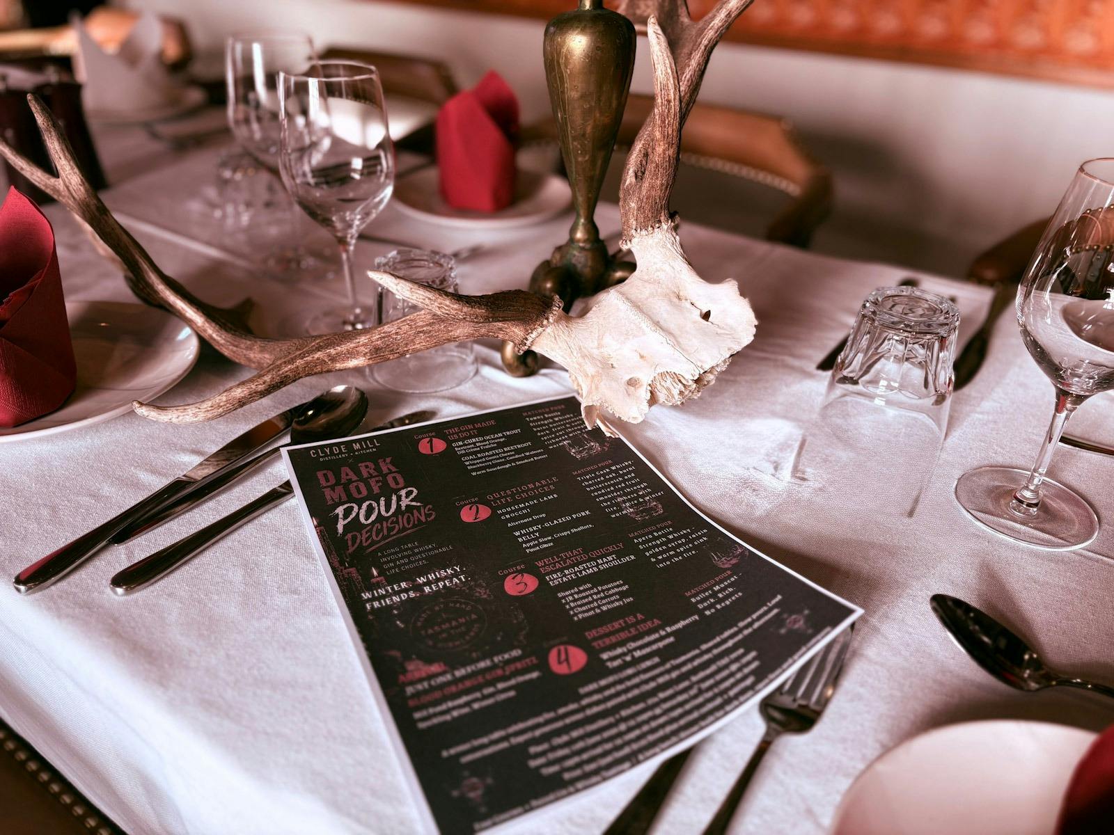 A dark and atmospheric long-table lunch/ dinner inside Clyde Mill Distillery + Kitchen,