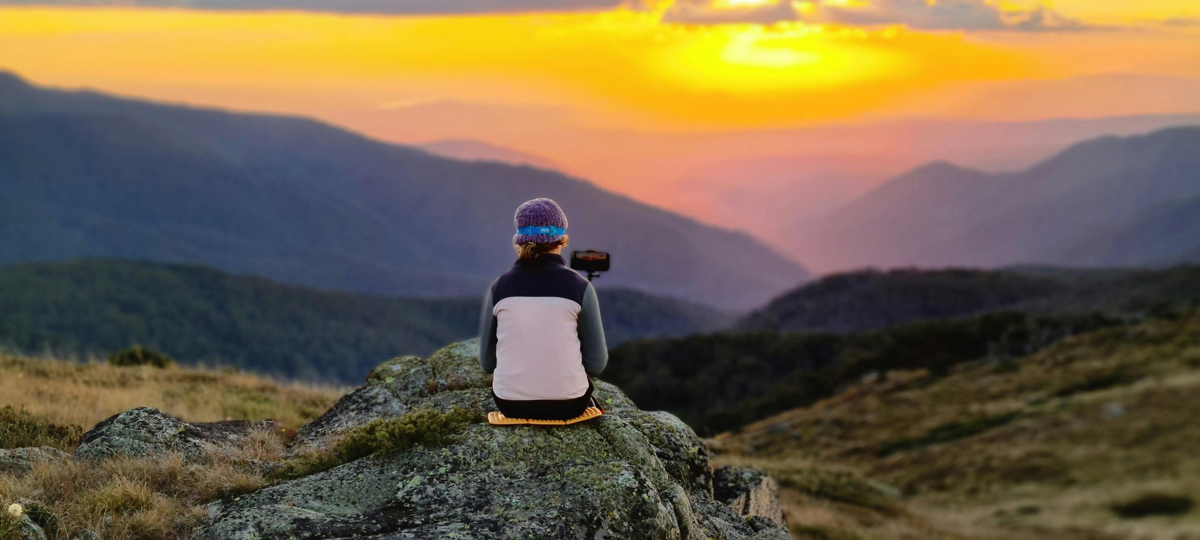 A 12 year old hiker watching sunset from the summit of Mt Stirling.