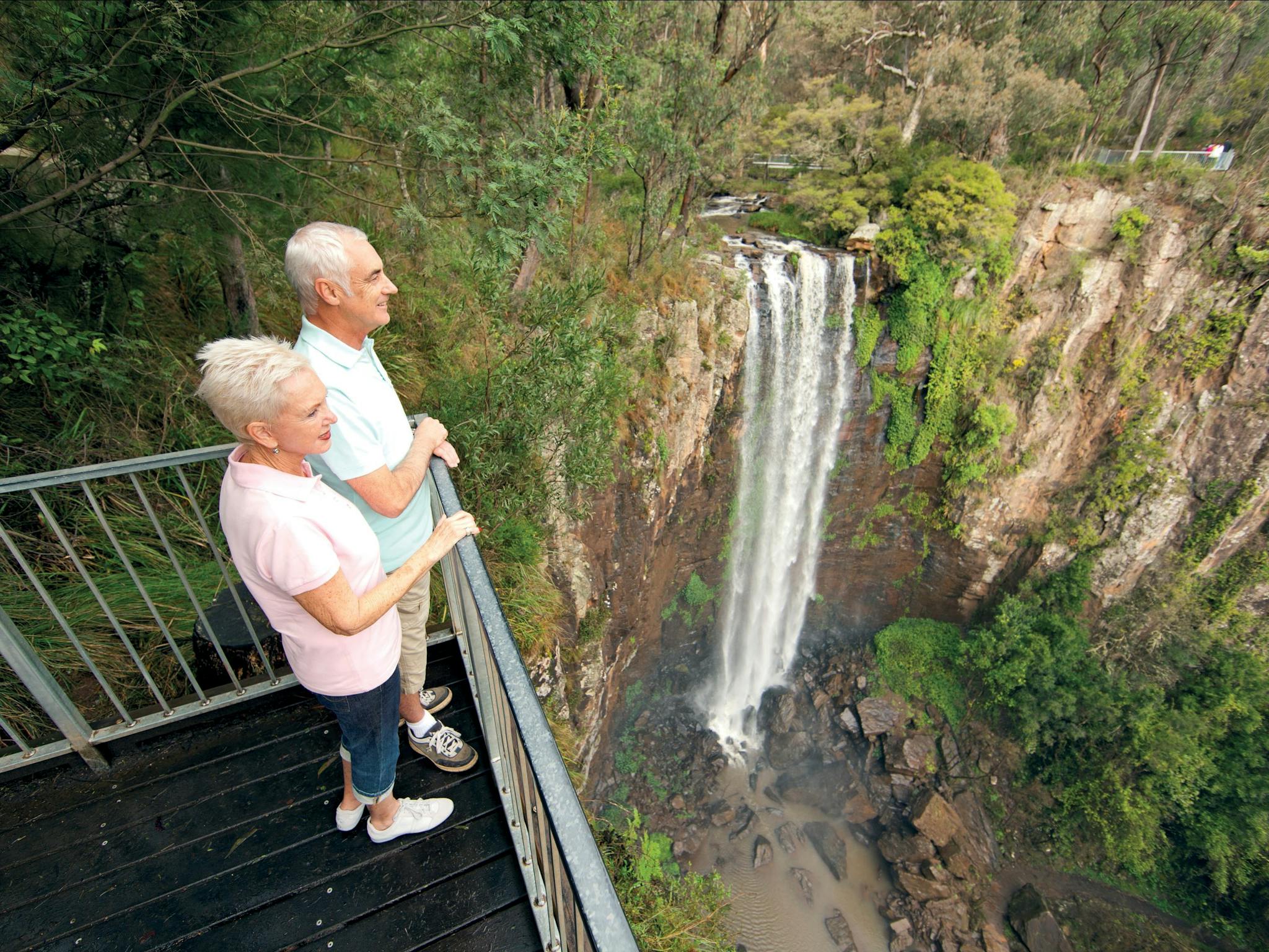 Couple on viewing deck overlooking falls.