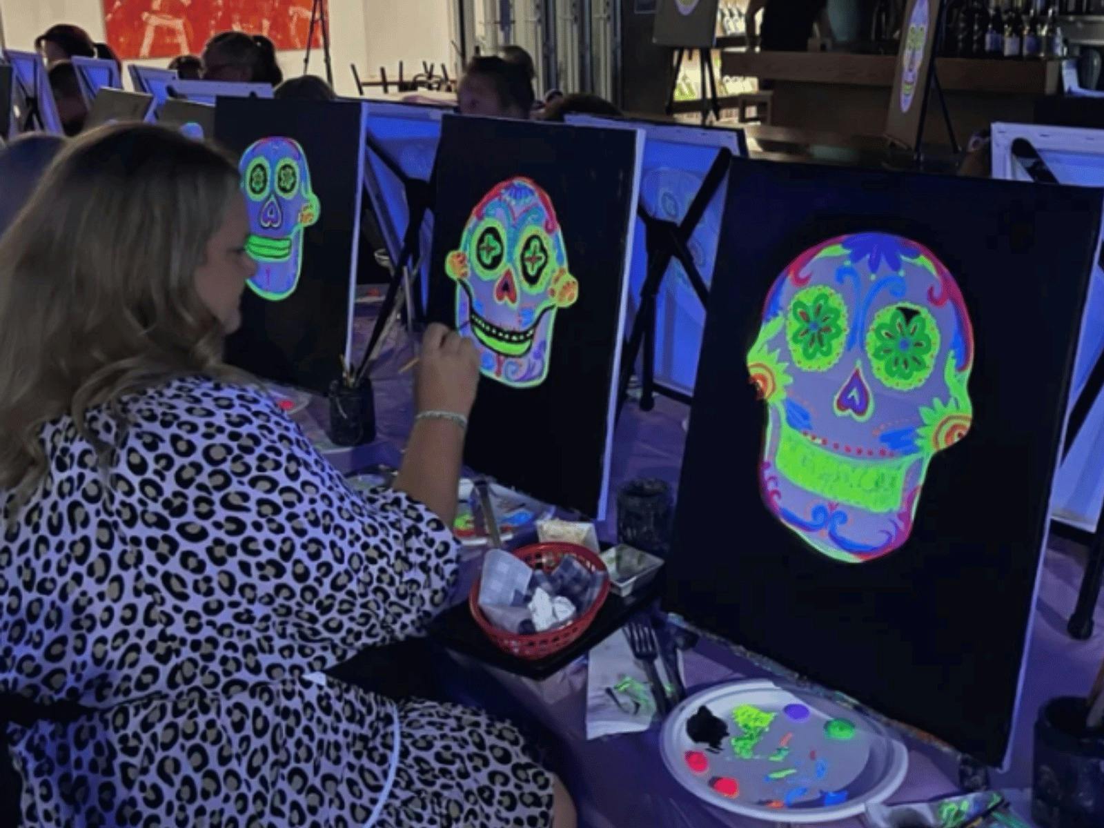 Guests painting Neon Sugar Skull