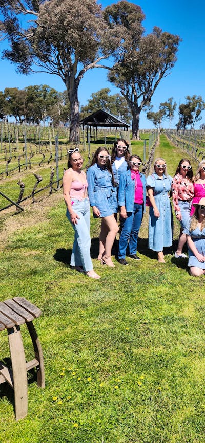 A diverse group of people standing together, smiling and posing for a photo.