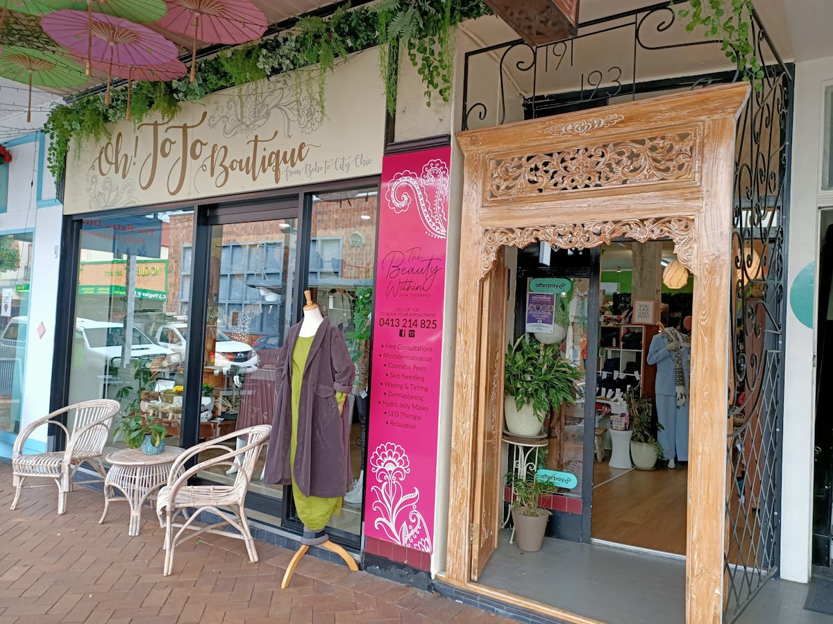 Street shot of the front of the store showing display window and beautiful timber doors.