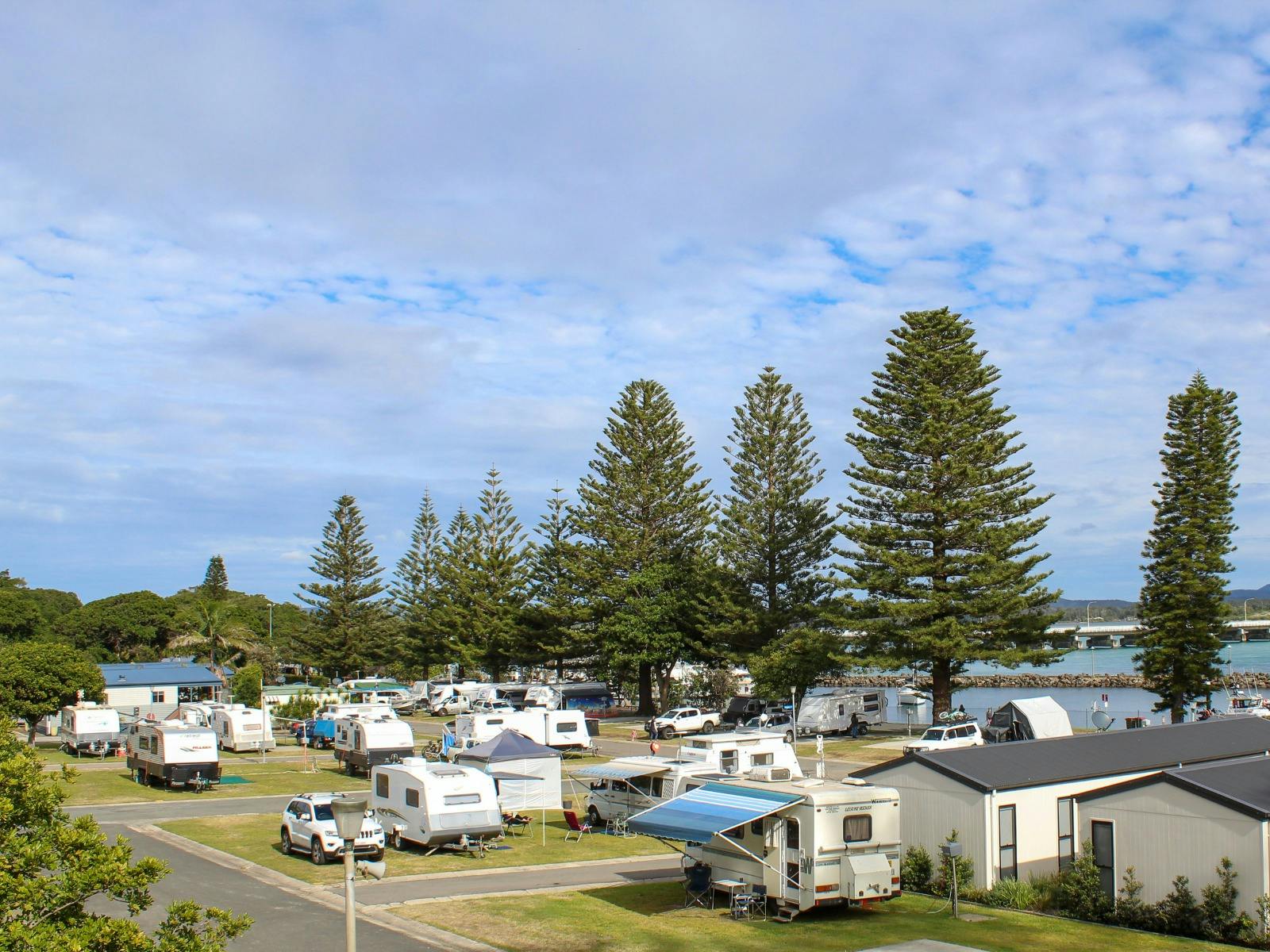 Cabins, caravans and cars across a caravan park.
