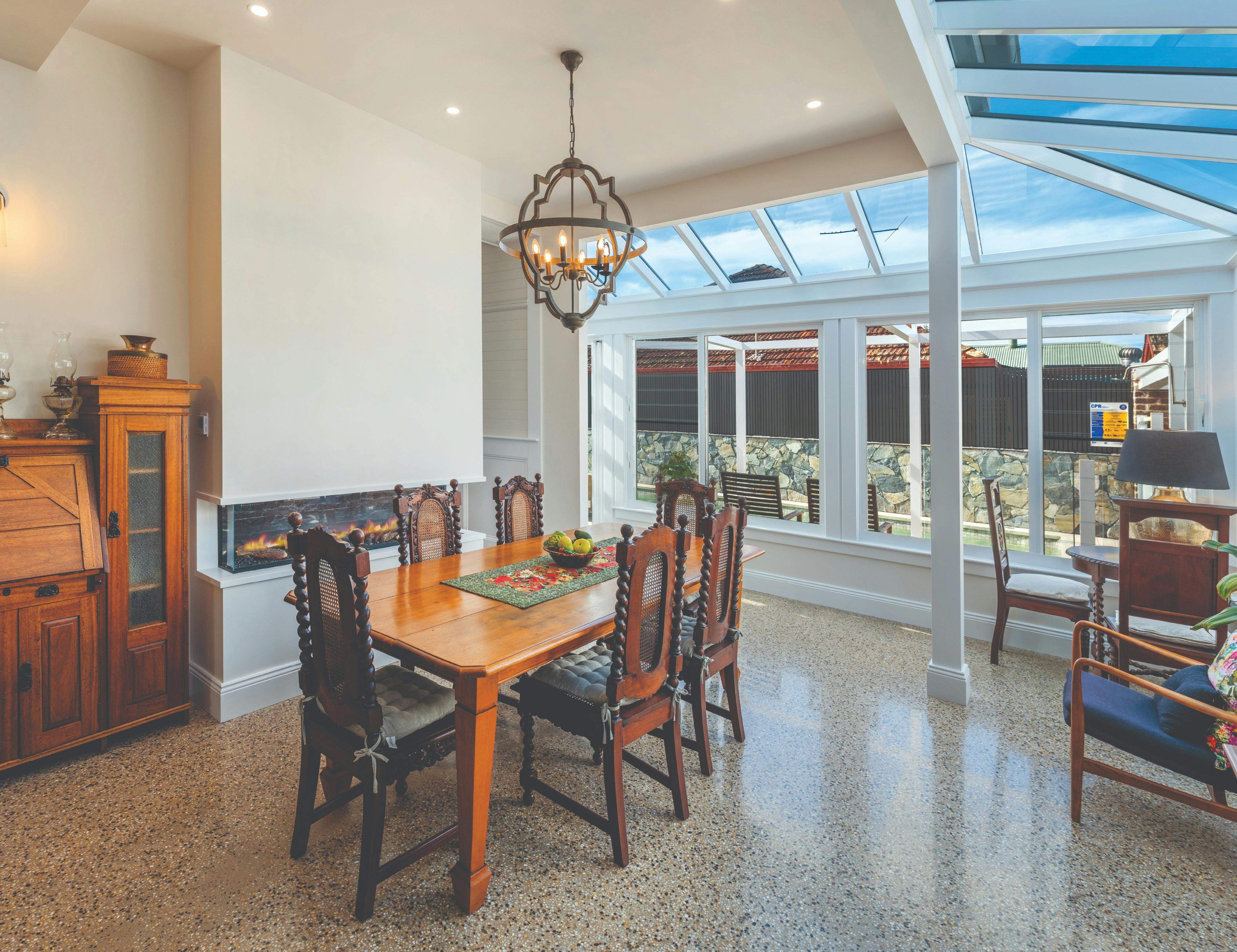Large dining room with underfloor heated polished concrete & electric fire adjoins a UA kitchen