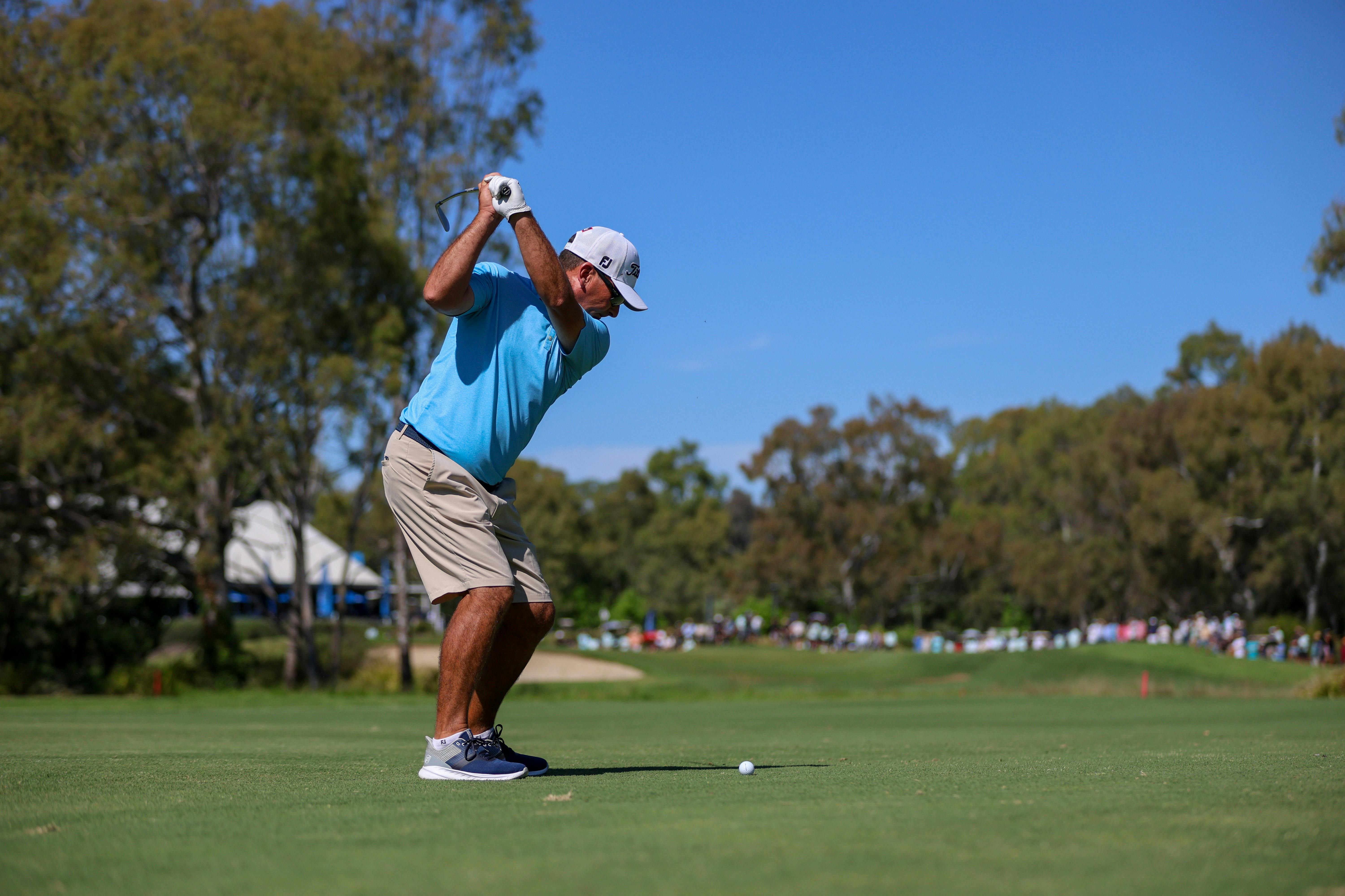 Golfer hitting a ball on the 18th hole