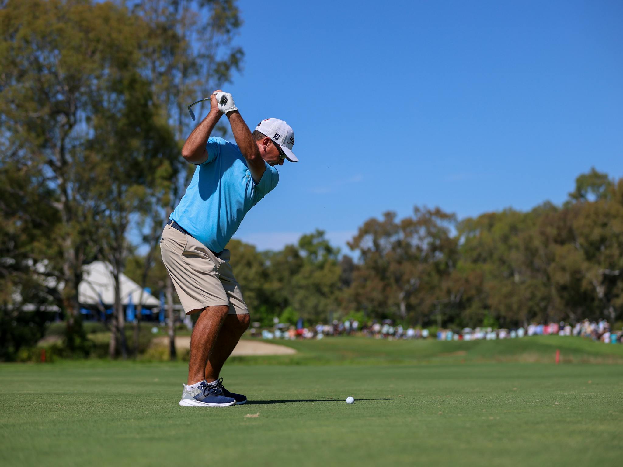 Golfer hitting a ball on the 18th hole