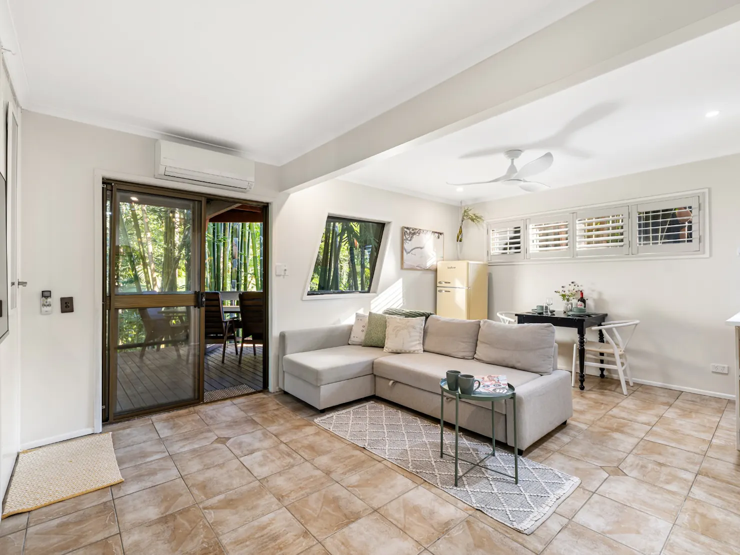 Open plan living, dining and kitchenette with balcony access