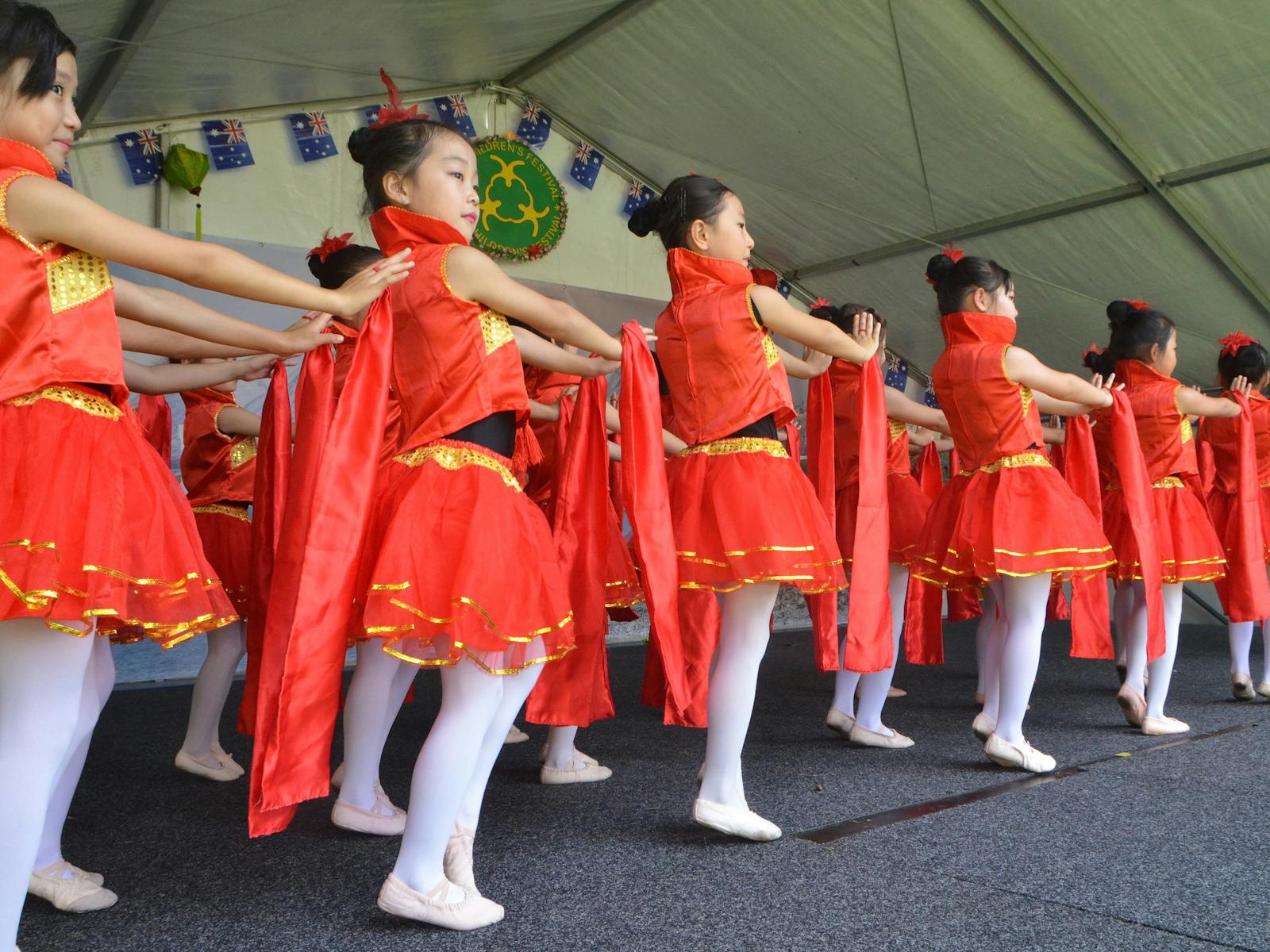 The children of Chinese immigrants enthusiastically perform colourful dances from modern China