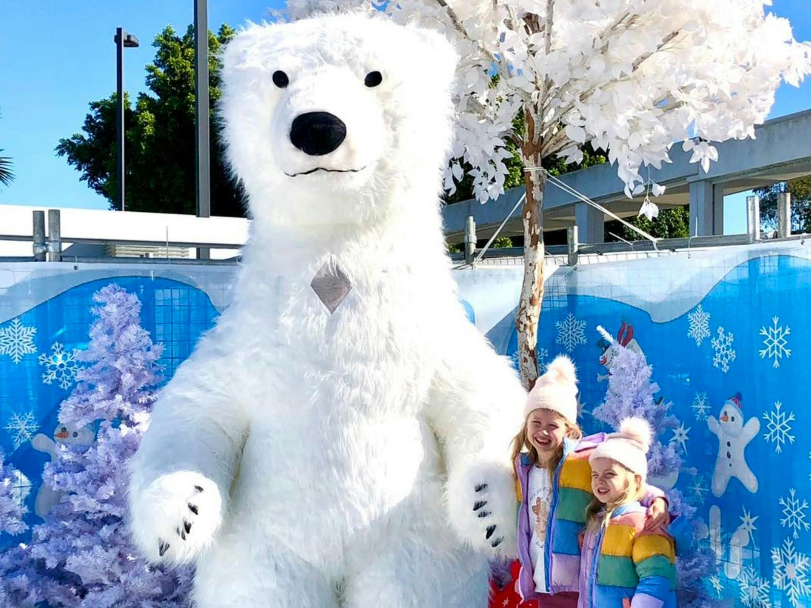 Children pictured with a polar bear character