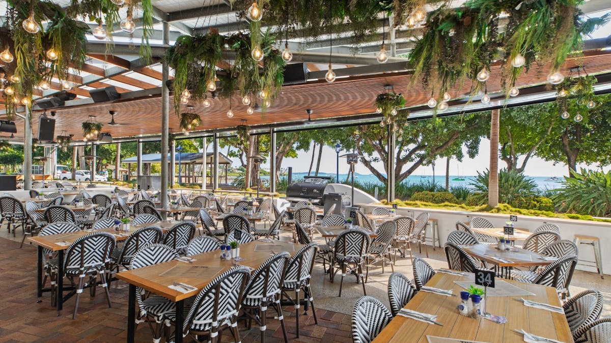Bistro area at The Pub, Airlie Beach Hotel, with outdoor seating, coastal decor