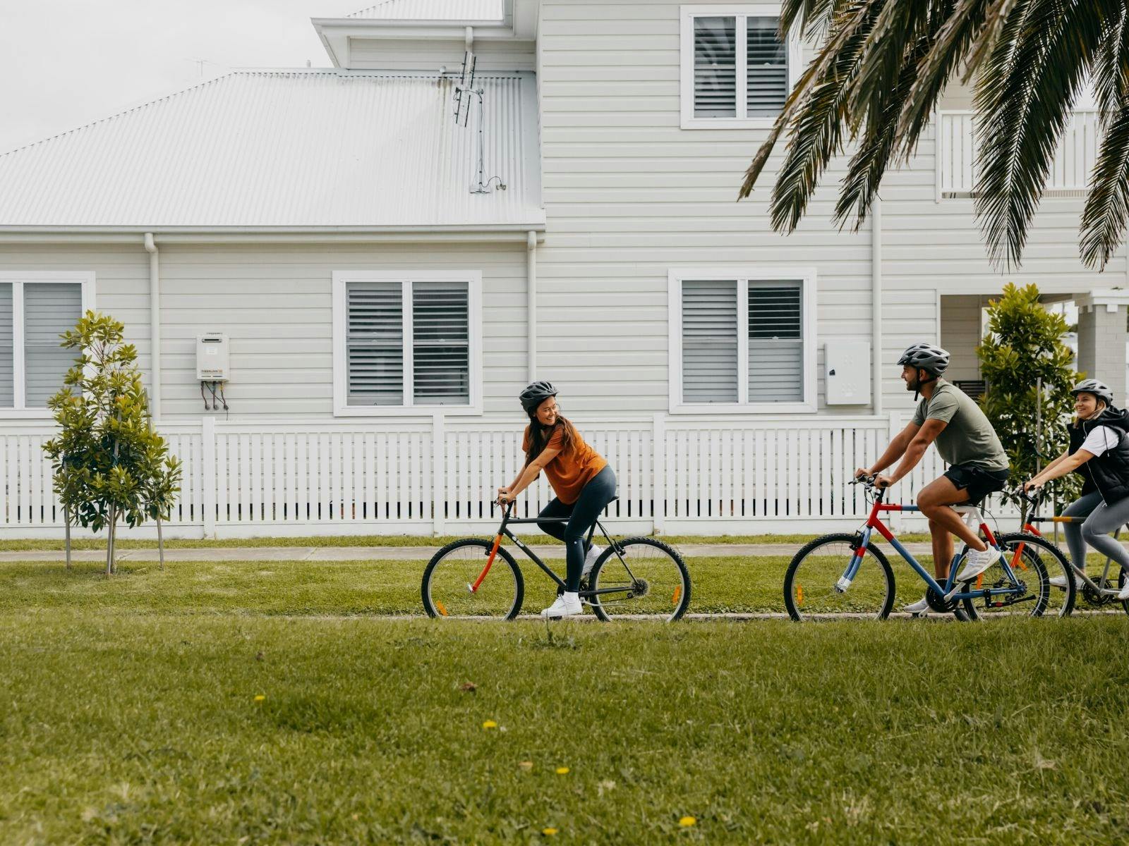 Guests riding bikes through the palm lined streets of Carrington