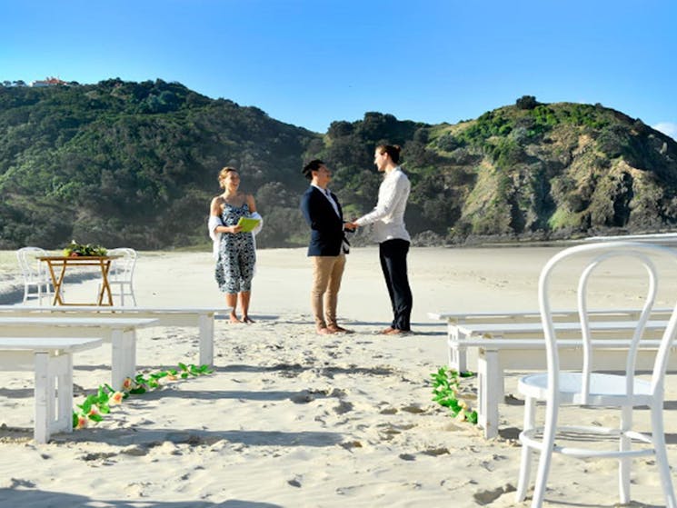 A couple saying their vows at Cosy Corner at Tallow Beach, Cape Byron State Conservation Area.