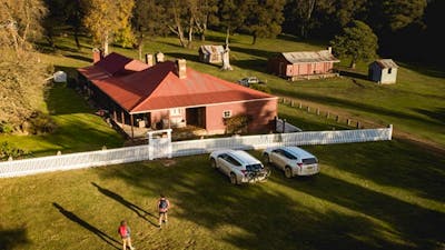 A bird's eye view of a couple walking towards Currango Homestead, Kosciuszko National Park. Photo: