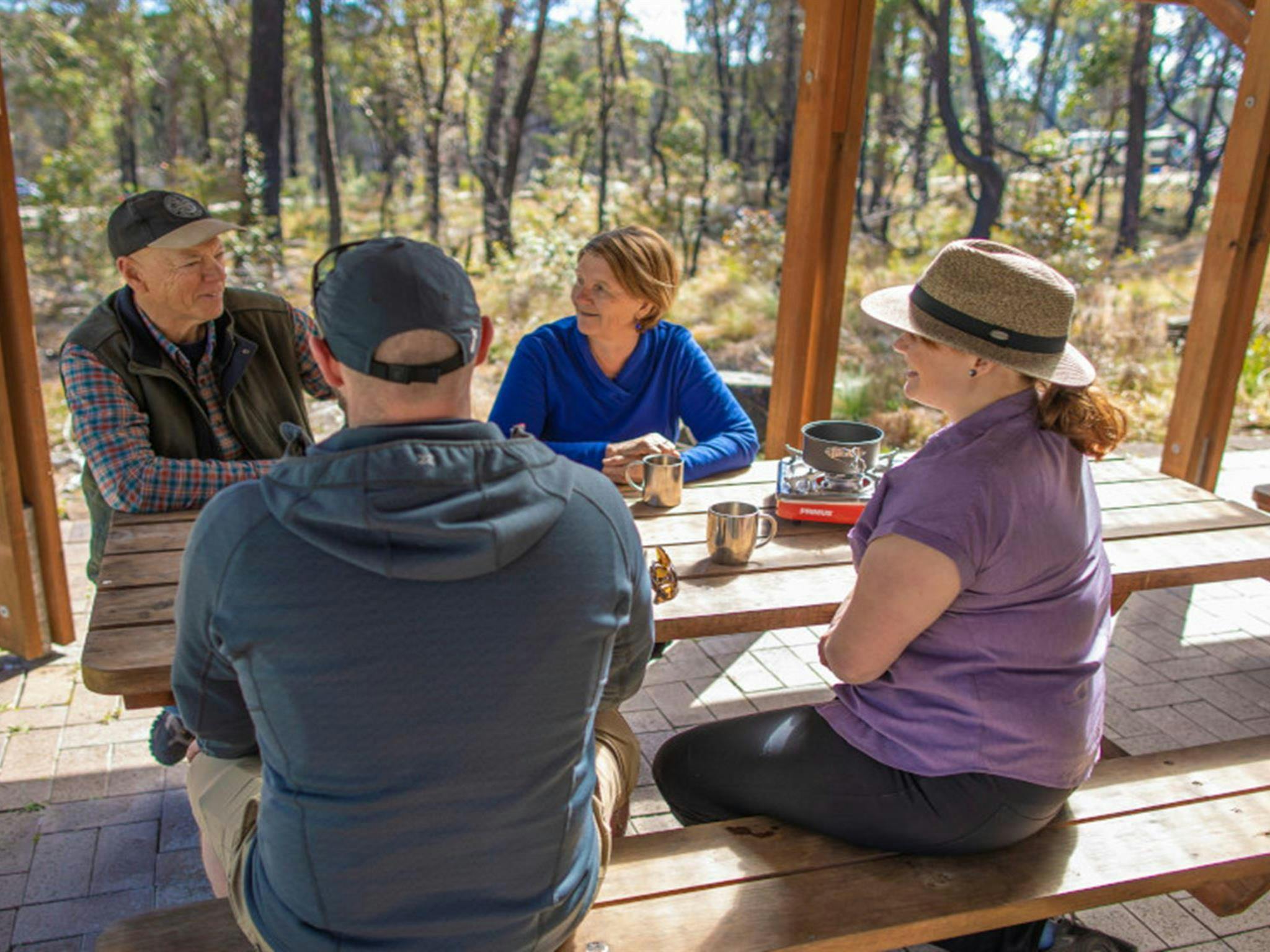 Campers siting at picnic tables, Cypress Pine campground. Credit: Joshua J Smith &copy DPIE