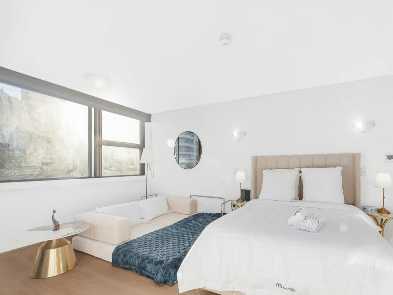 Spacious studio bedroom with comfortable bed and contemporary furnishings