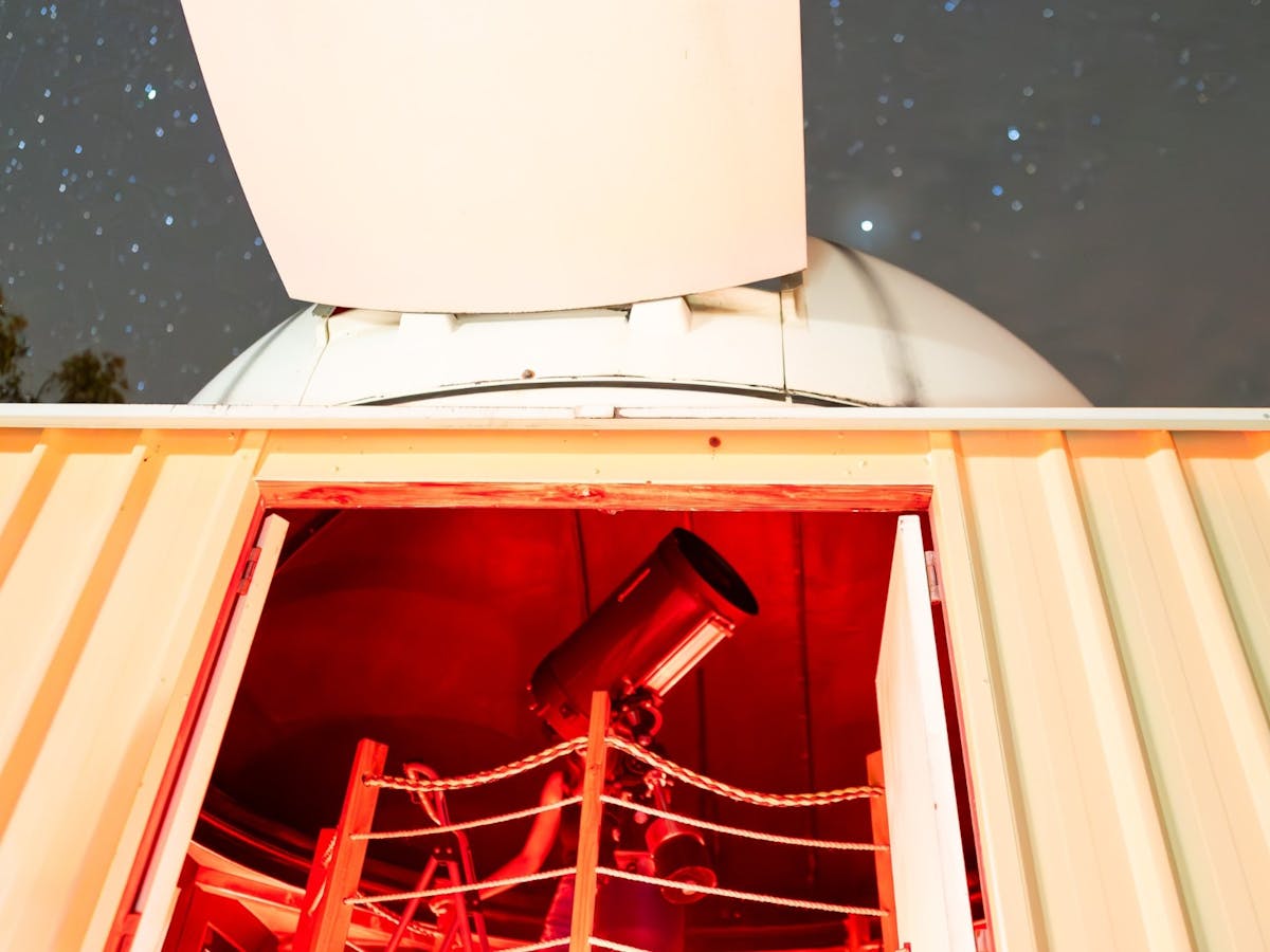 Inside the observatory showing the telescope and starry sky at the Chillagoe Observatory & Eco Lodge