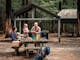 family of four at a picnic table near Masons Falls