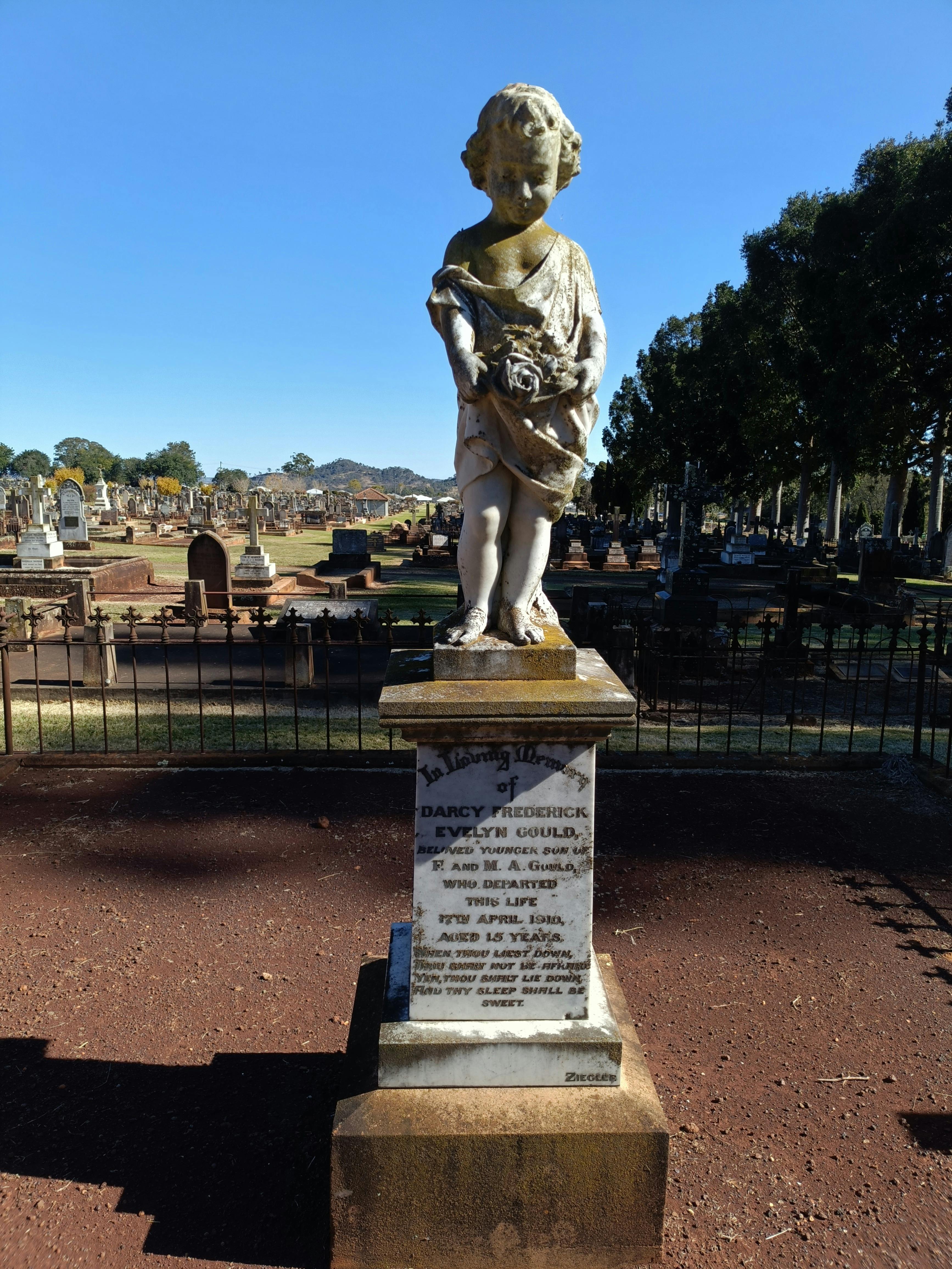 Stunning marble cherub memorial stands over a grave at the Drayton and Toowoomba Cemetery