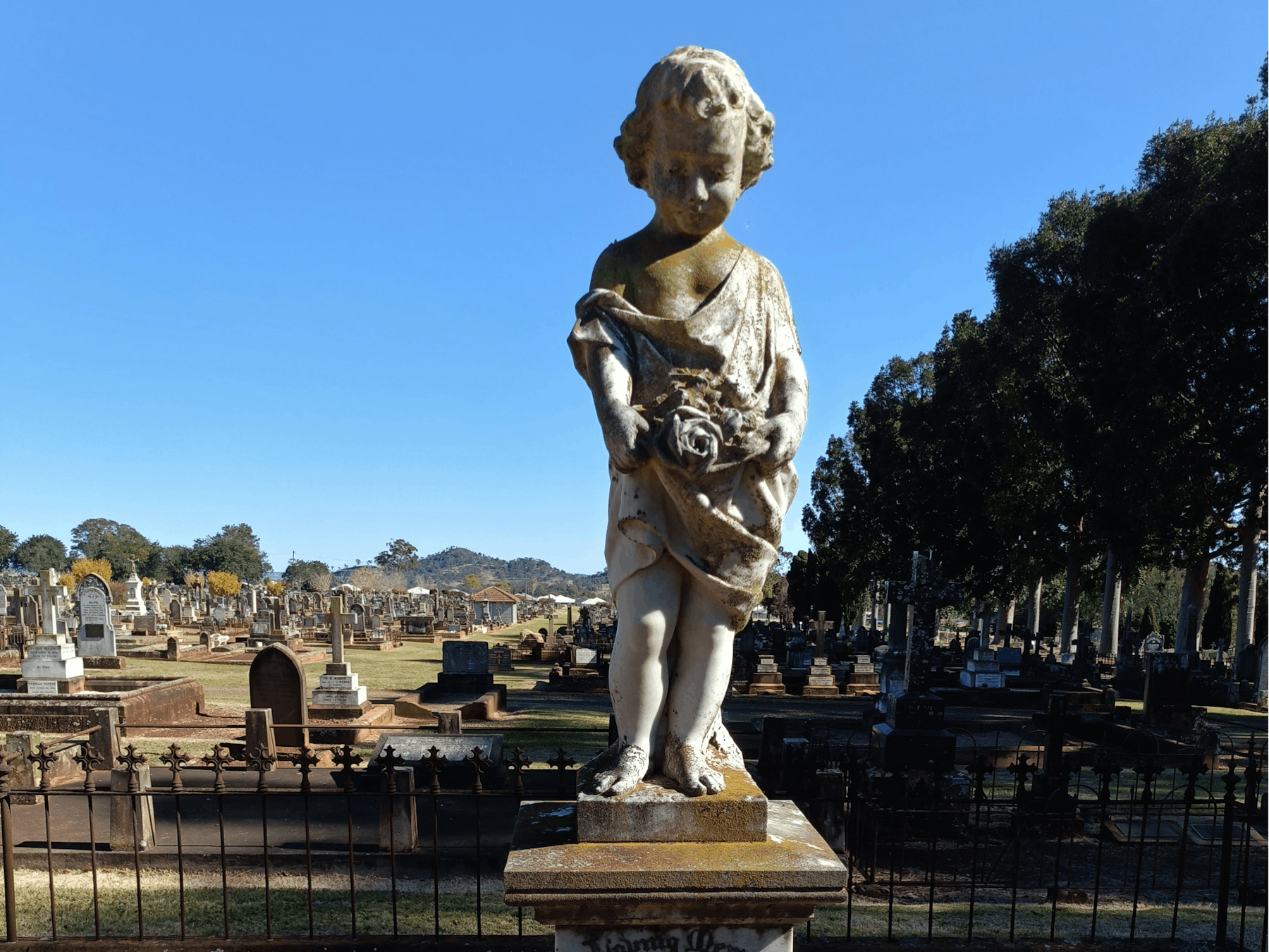 Stunning marble cherub memorial stands over a grave at the Drayton and Toowoomba Cemetery
