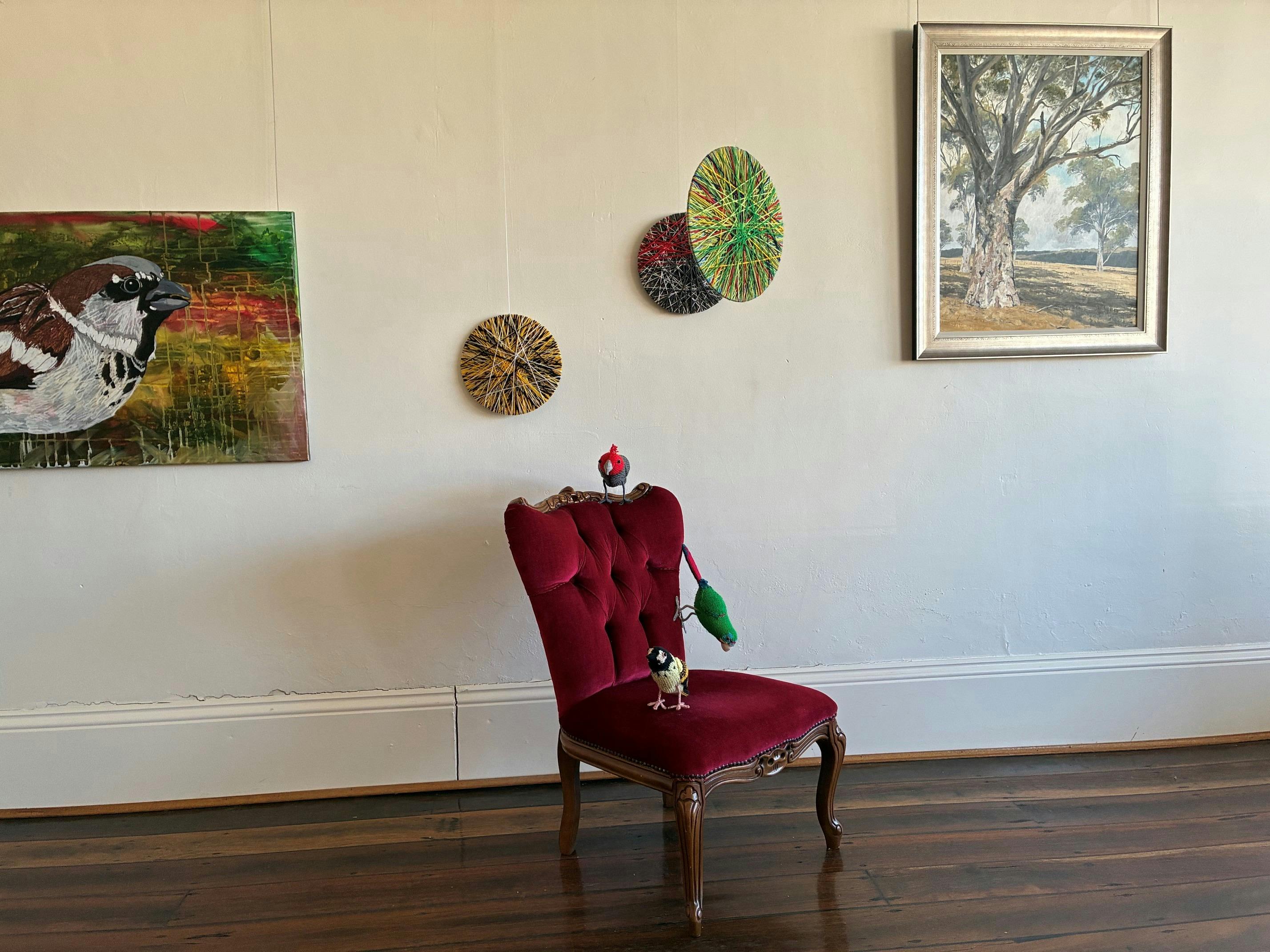 Artworks on walls and plinths in a room
